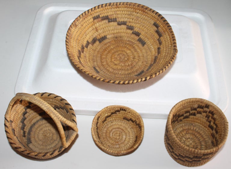 Group of 4 Small 20th C Papago Indian Baskets.
Measurements are approximate - 

Handled Basket - 5 wide x 4.75 deep x 5 high

Smallest basket - 3.75 diameter x 1.75 high

Medium basket -4 diameter x 3.75 high

Largest basket- 8 diameter x