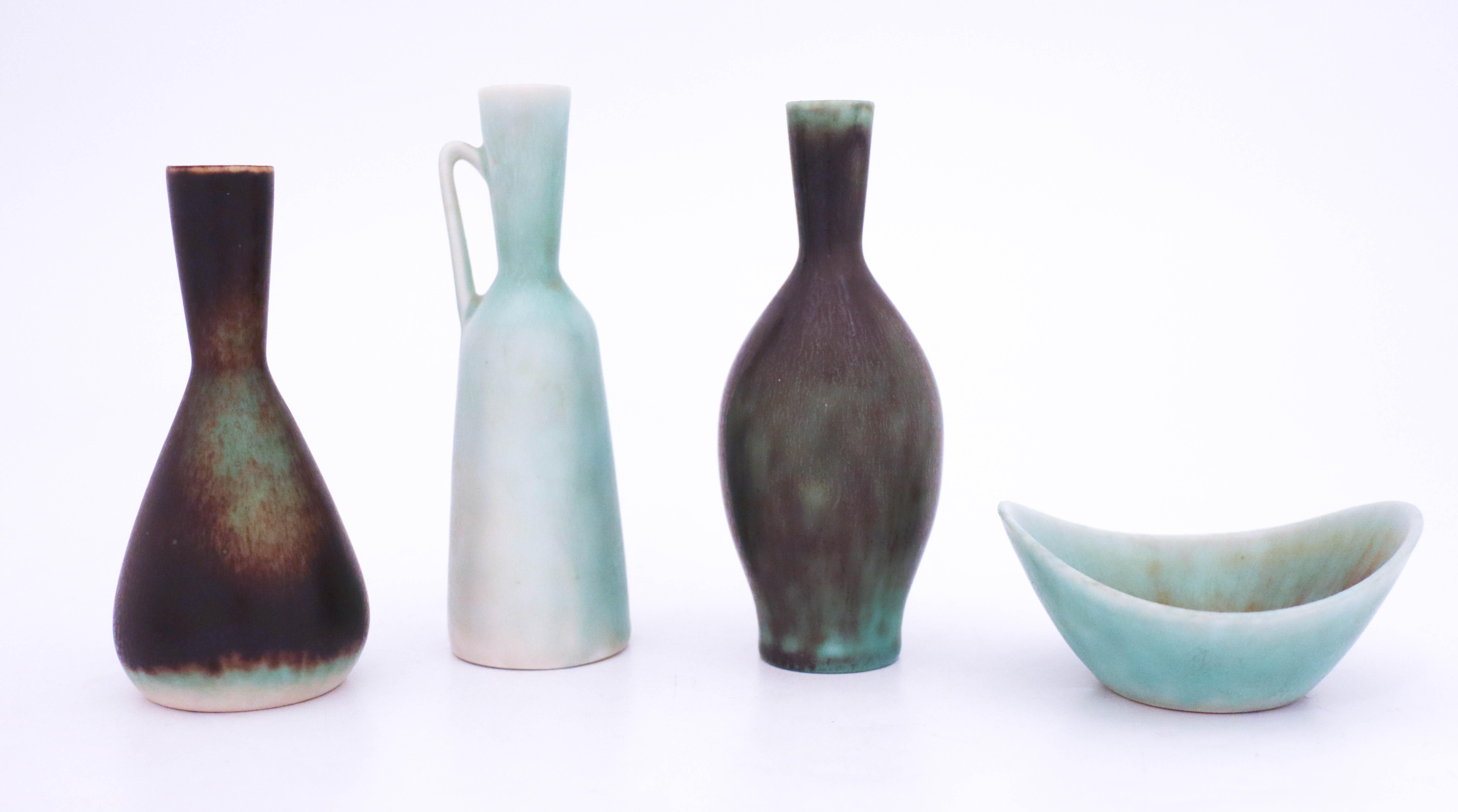 A group of four vases designed by Carl-Harry Stålhane at Rörstrand in turquoise to dark green or black color. The vases are 12.3-10.5 cm high and the bowl is 8.5 x 7 cm in diameter, all of them are marked as 1st quality. They are in very good