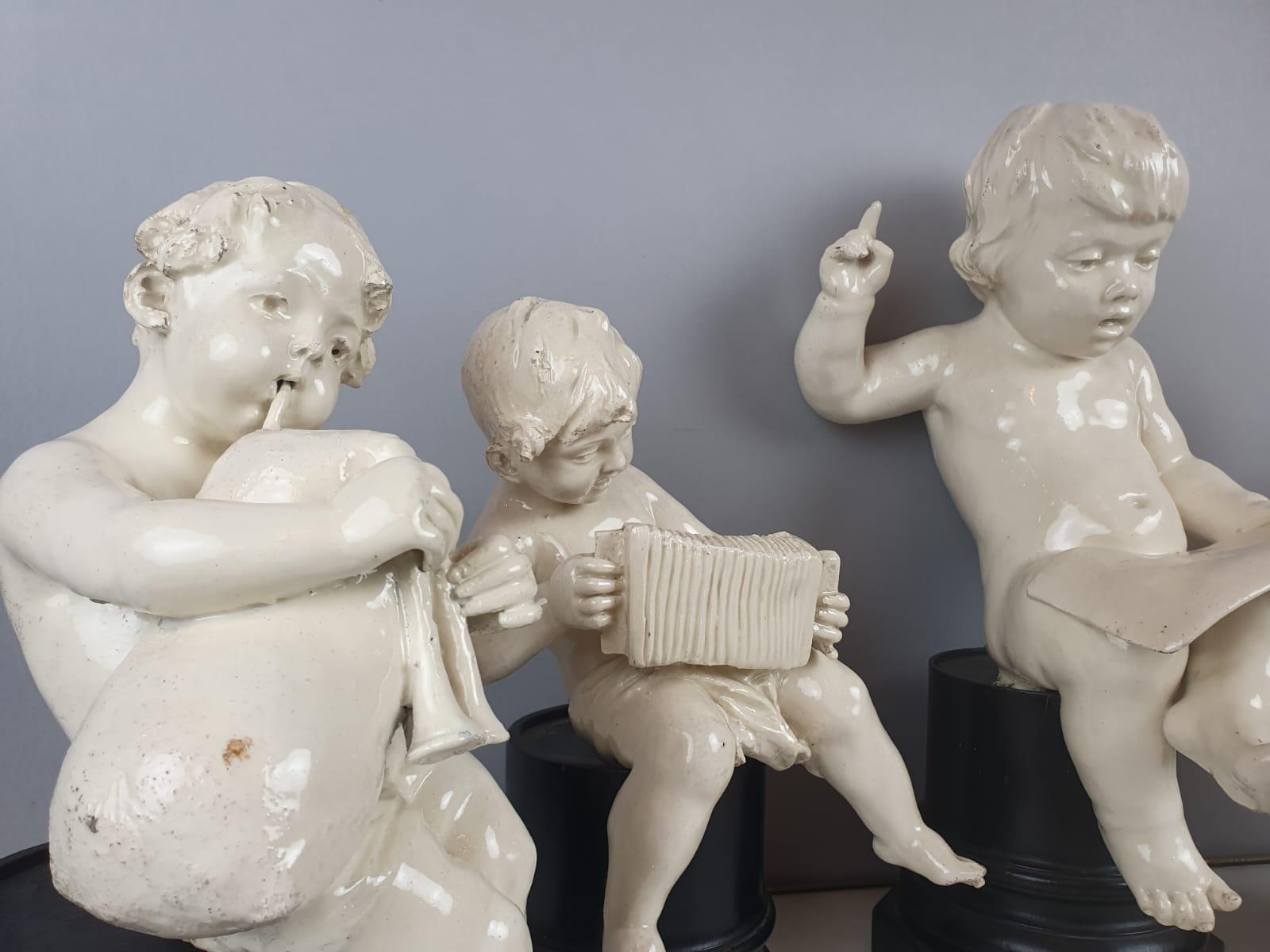 Rococo Revival Group Of 5 Earthenware Musician Cherubs, Late 19th, Early 20th. For Sale