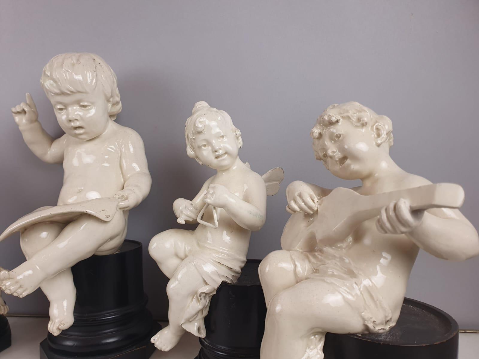 European Group Of 5 Earthenware Musician Cherubs, Late 19th, Early 20th. For Sale