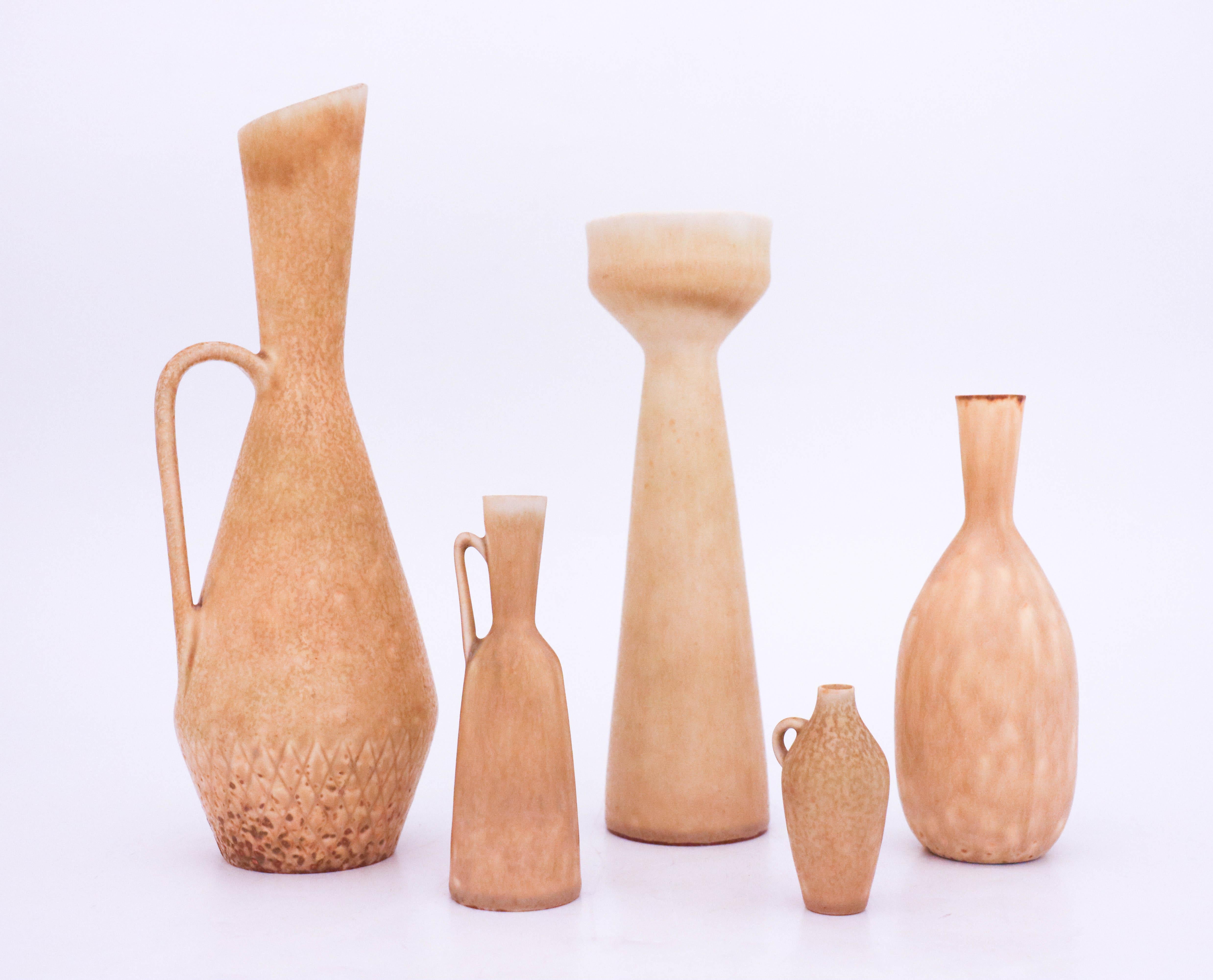 A group of five vases designed by Carl-Harry Stålhane at Rörstrand in beige/yellow color. The vases are 26, 22, 15, 12,5 and 6,5 cm high. They are all marked as 1st quality except from the one in the middle that is 2nd quality. They are in very good