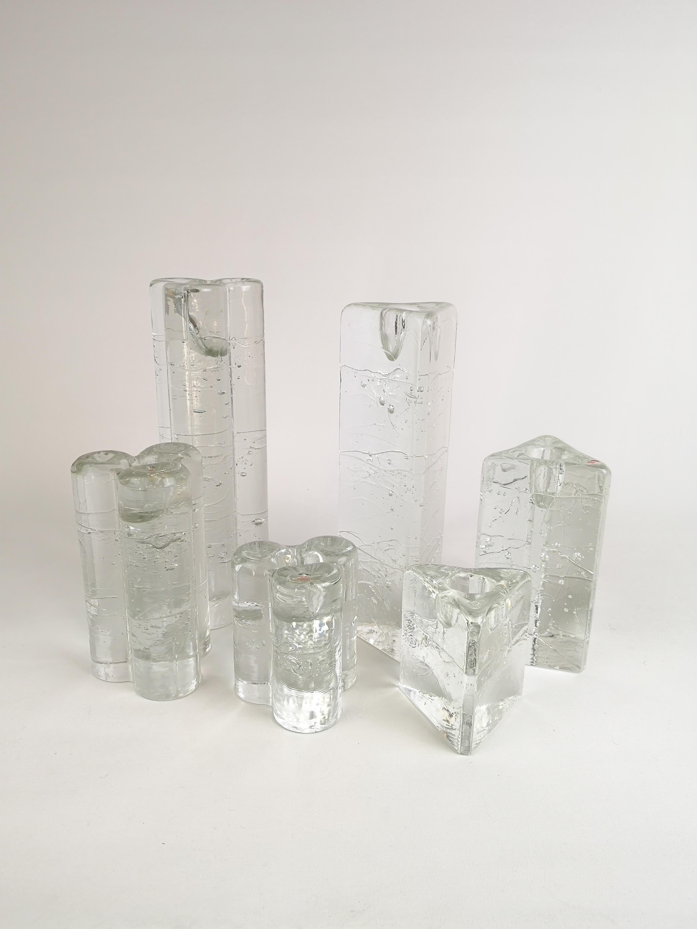 Group of 6 Iittala Arkipelago candlesticks in round and triangular forms.
Architectural cast clear glass blocks.
With bubbles. They are created to appear as if they were is blocks. They are designed by Timo Sarpaneva in the 1970s for Iittala