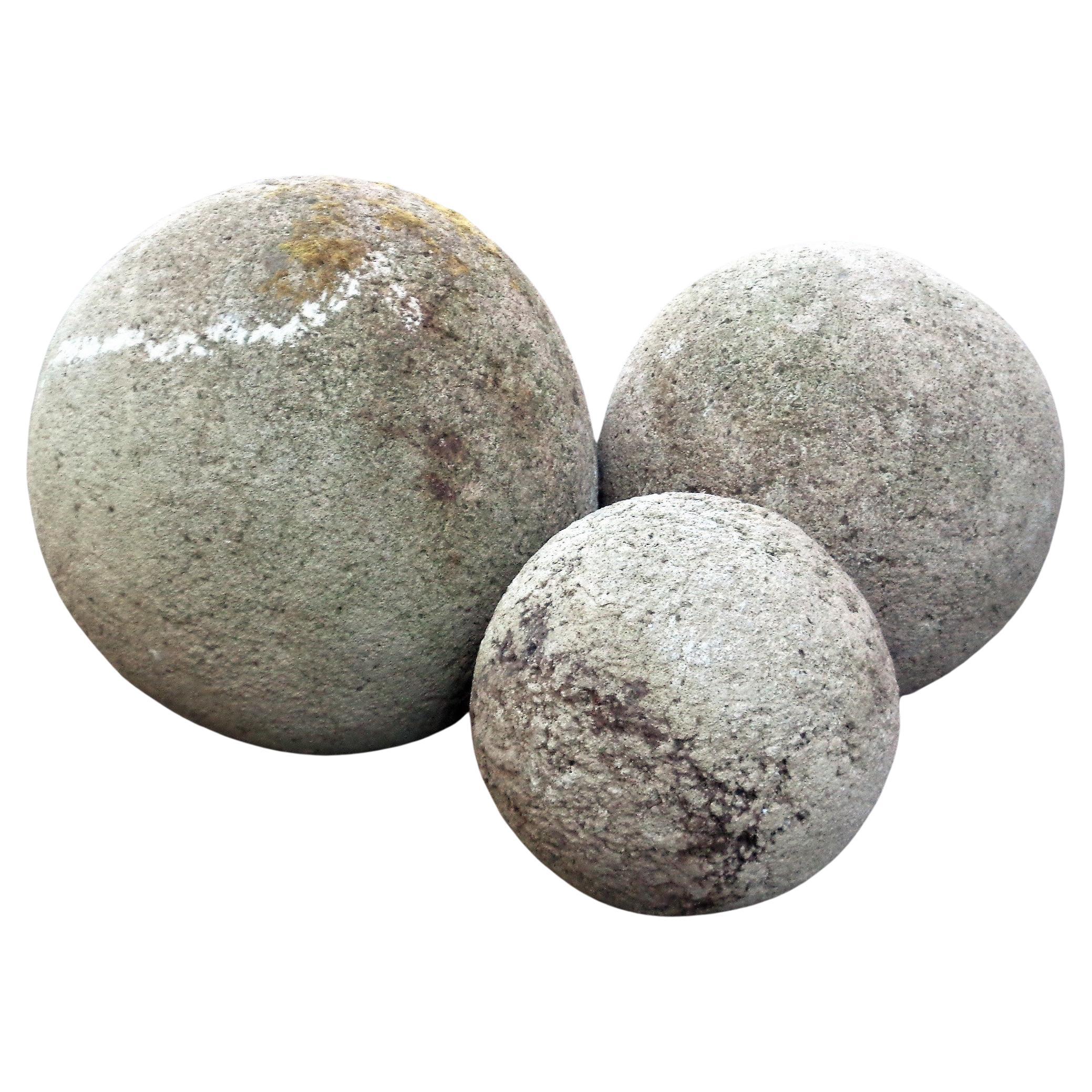 A graduated size grouping of three hand crafted crushed stone aggregrate garden spheres in nicely aged weathered surface w/ areas of light greening and some lichen growth. Look at all pictures and read condition report in comment section.