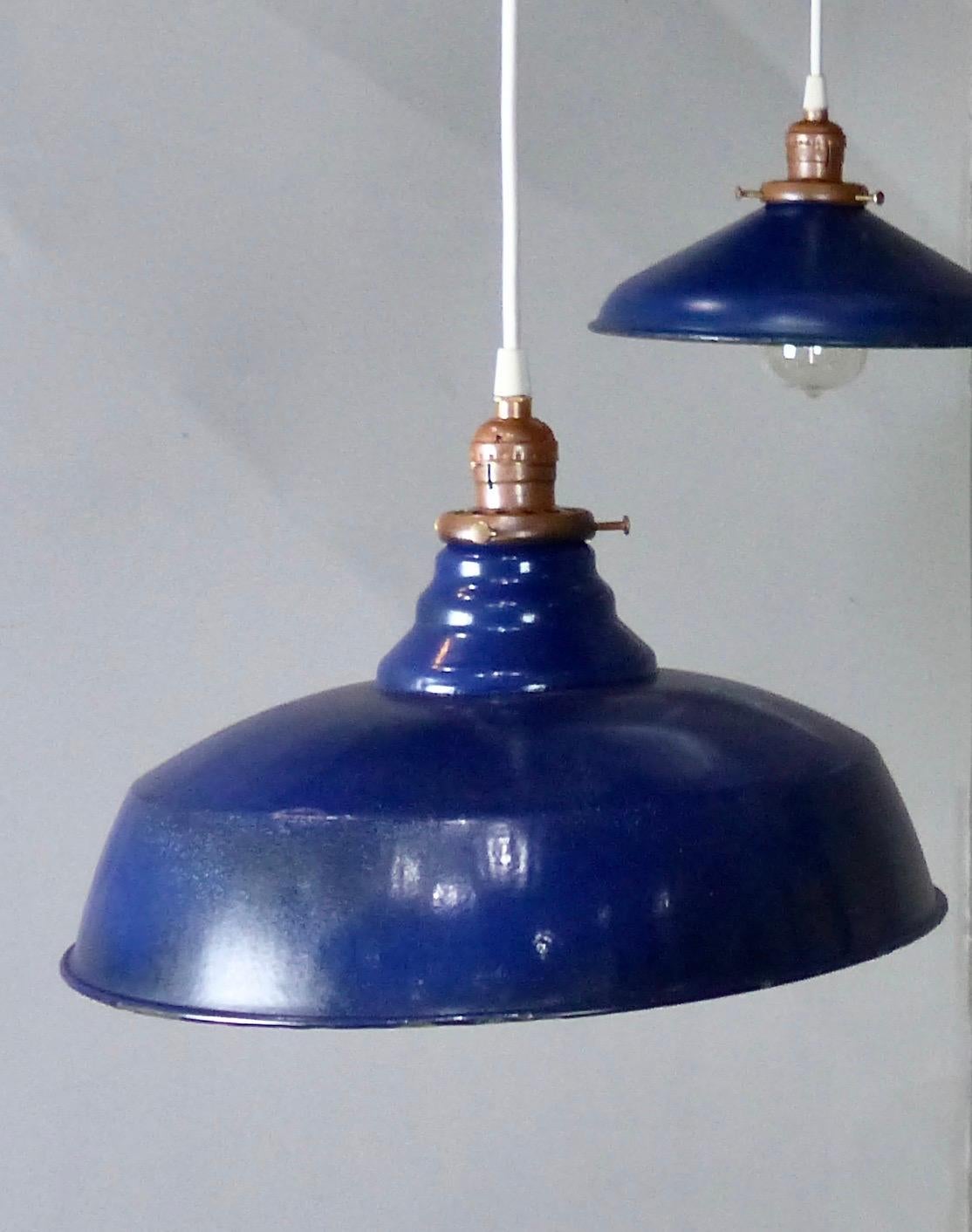 Interesting assortment of Industrial pendant lights in various shapes and sizes — all in blue enamel coloring. Hang at various heights to create an intriguing focal point. Re-wired and CSA approved to current electric standards; ceiling mounting