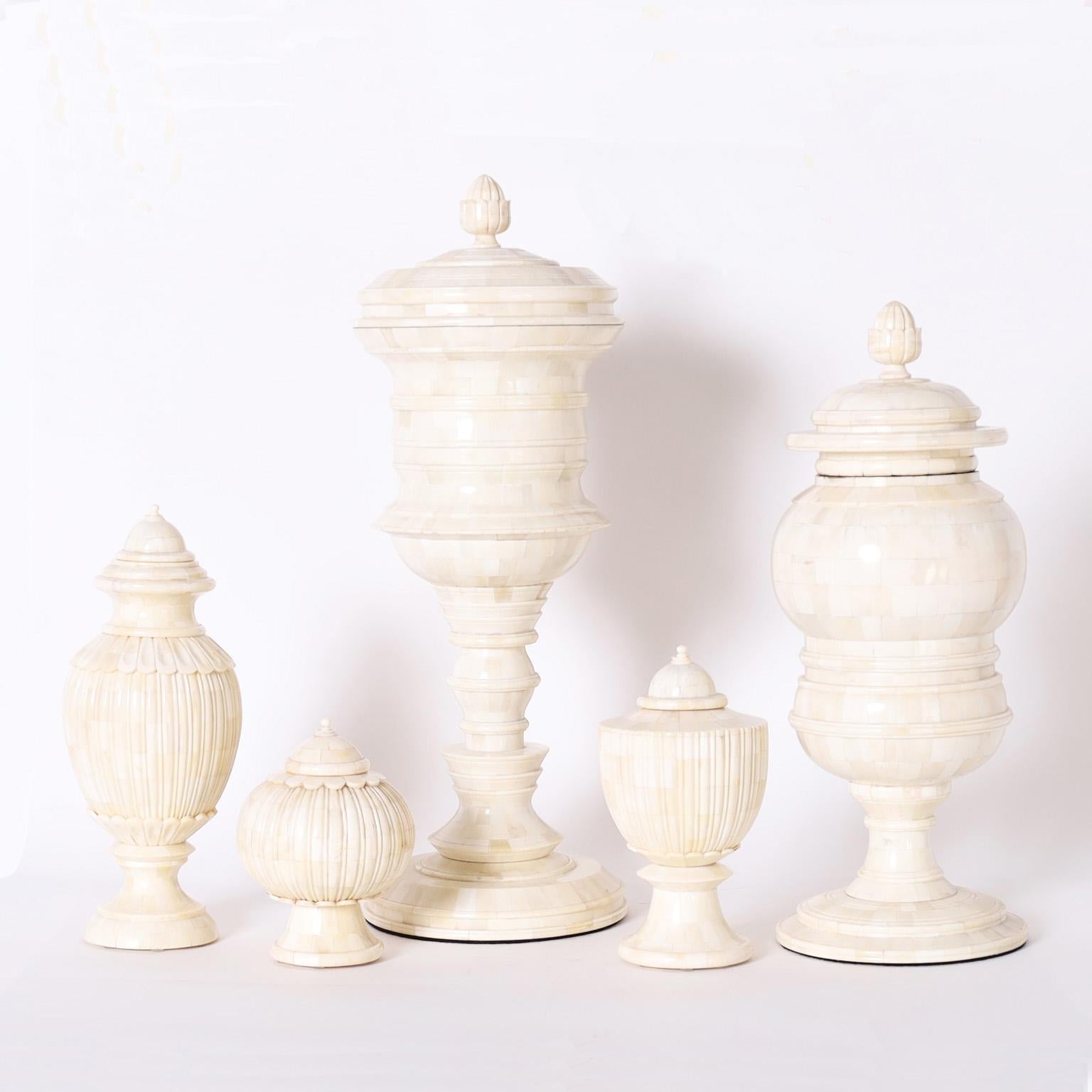 Impressive group of five British colonial style lidded urns all with their distinctive adaptations of classical form, crafted in turned and carved bone. Signed Tozai on the bottoms. Priced individually. 

H: 13 DM: 5 $850

H: 7 DM 5 $515

H: