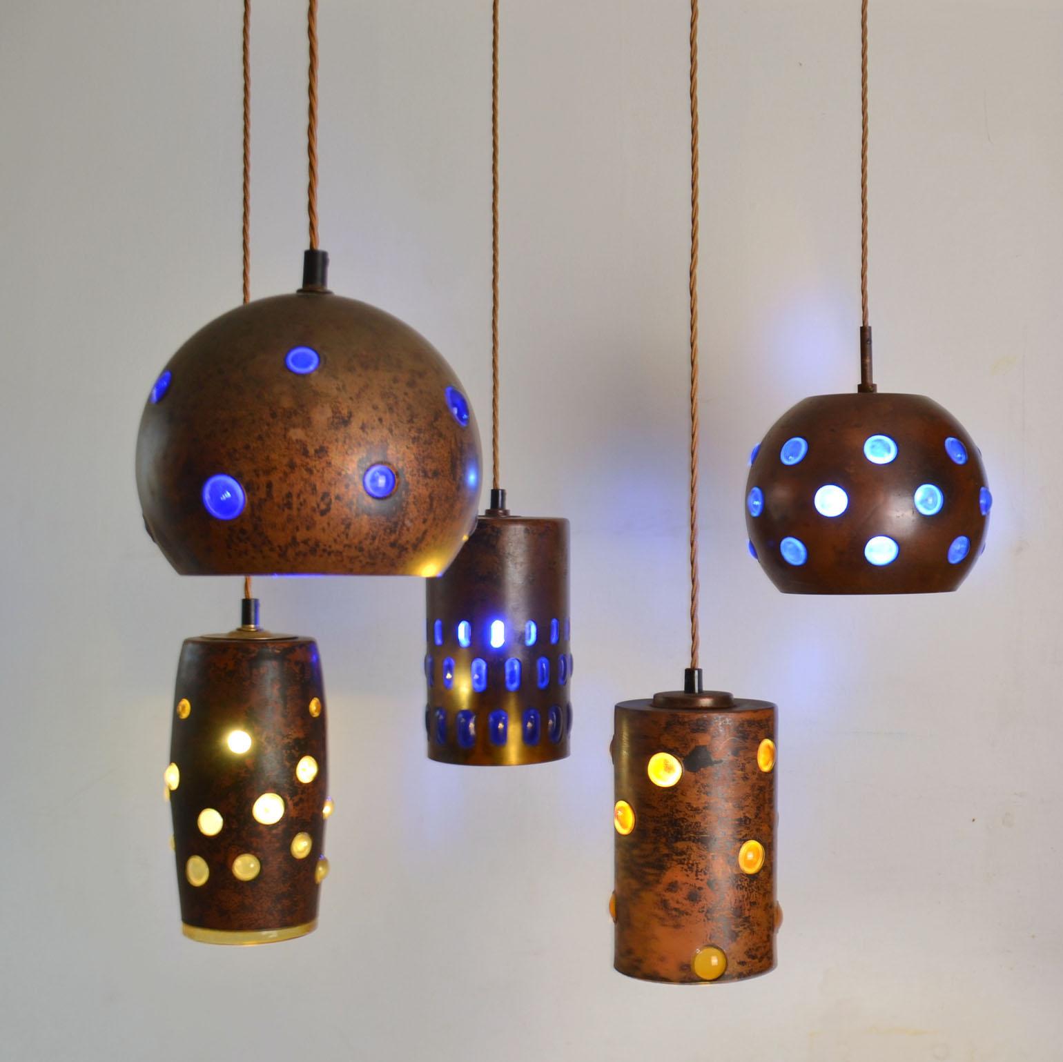 Mid-Century Modern blue and amber pendant lamps are made from blown glass & oxidized copper. They are all unique in execution. The deep blue and amber expanded glass is blown with regularity into external patinated copper spherical or rectangular