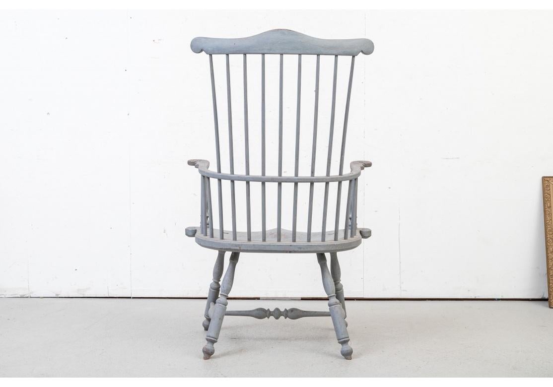 A fine set of hand-crafted comb back windsor chairs with traditional form in an unusual non traditional size. Having turned legs and base stretchers, peg construction, carved sheaf motif on the crests and a fantastic array of traditional milk paint