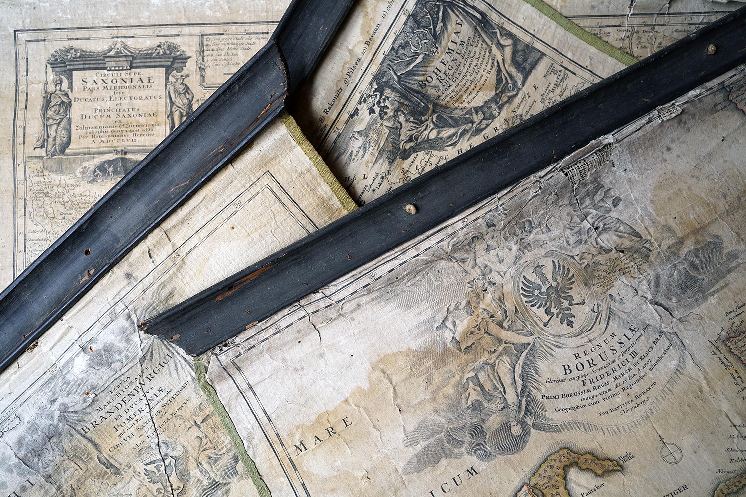 The hand-coloured maps in as found attic condition, each with their original ebonised pine rods for scrolling and lime green borders, in beautifully faded order showing various regions from Bohemia, Saxony and the Baltics with beautiful illustrated