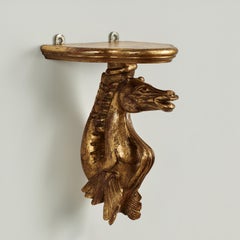 Gruppo di quattro antiche staffe da parete italiane a cavalluccio marino