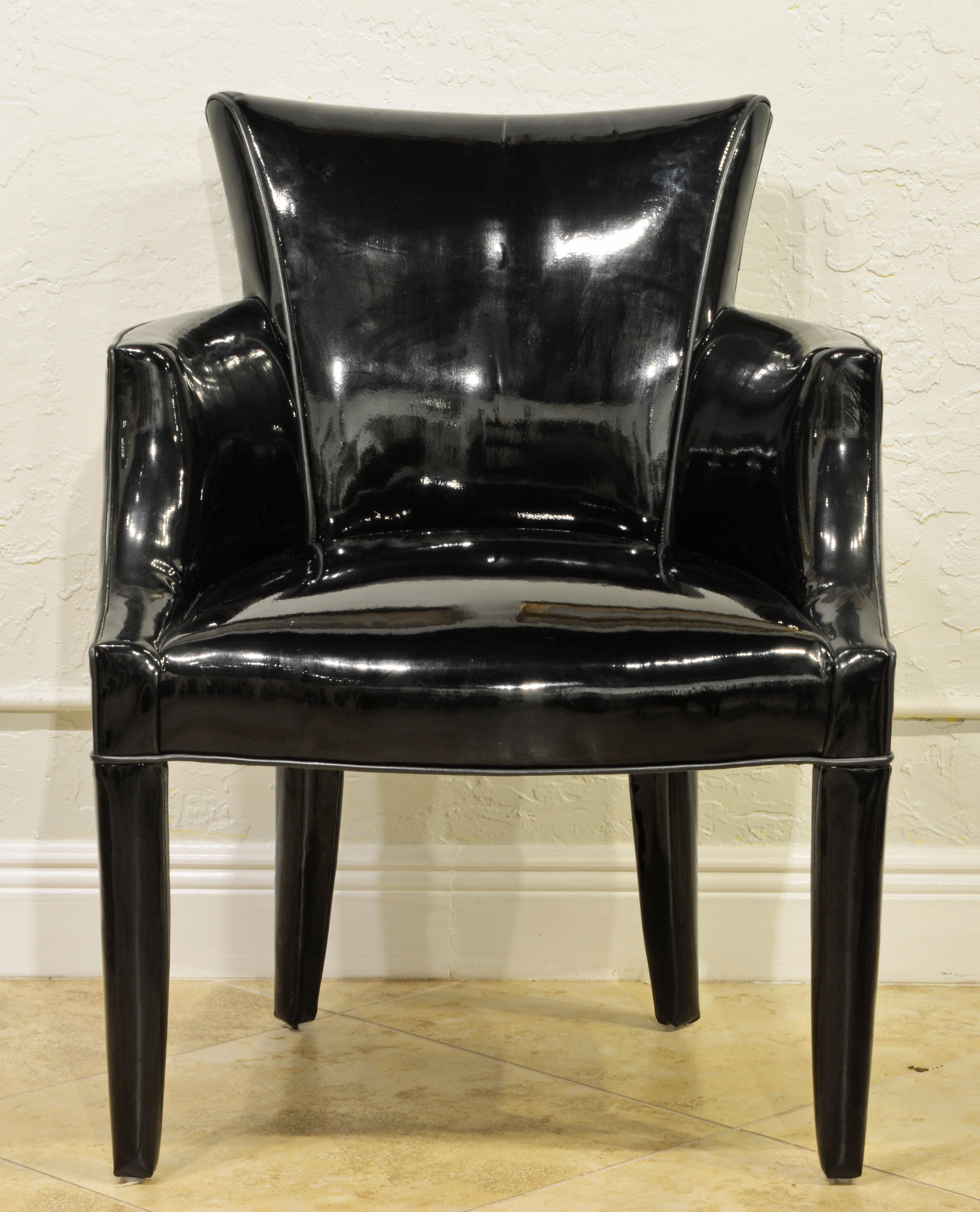 Fully upholstered including the legs in black shiny vinyl these chairs are strikingly modern and chic yet designed in a traditional mode. The chairs are very comfortable and can be used as lounge chairs as well as dining chairs.