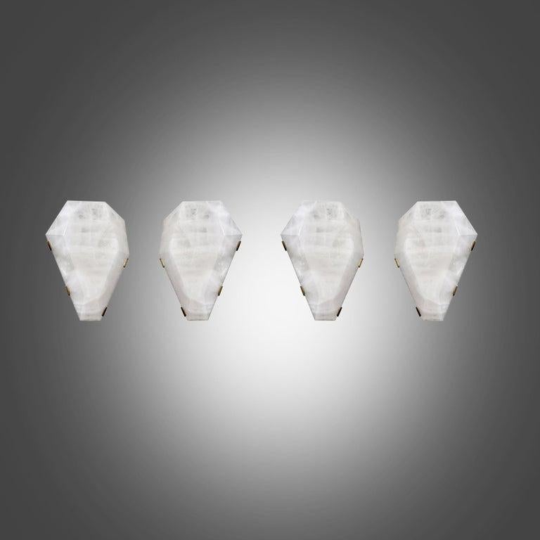 Group of four fine carved diamond form rock crystal sconces with antique brass mounts. Created by Phoenix Gallery, NYC.
Each sconce installed two sockets, use candelabra lightbulbs, 120W total
Custom size and metal finish upon request.