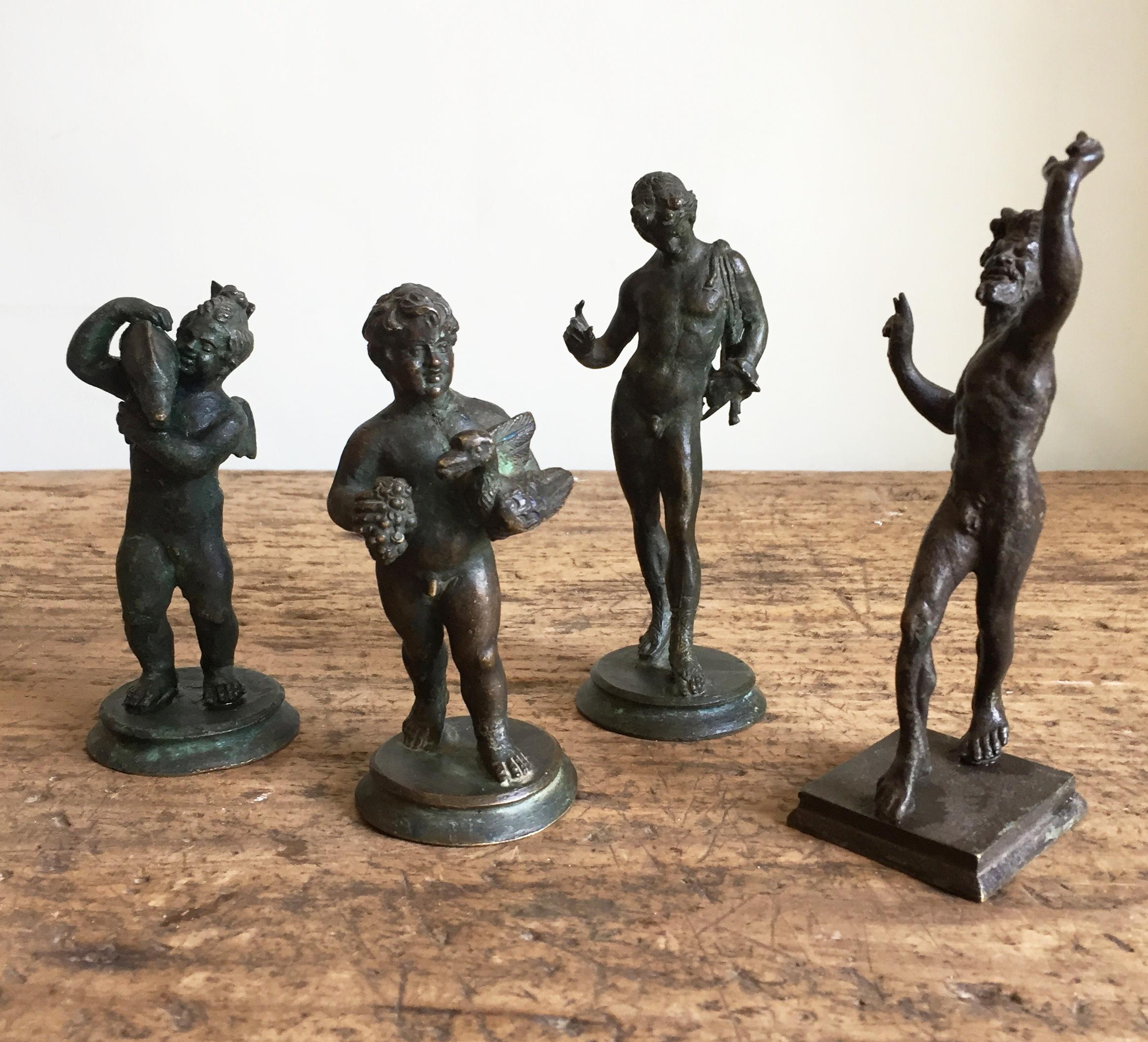 A group of four grand tour bronzes from Pompeii.

The small pair both being fountain heads, known as Amore con Delfino and Putta con Oca.

The larger pair is the dancing faun and narcissus.

A wonderful group of rare statues. Most probably