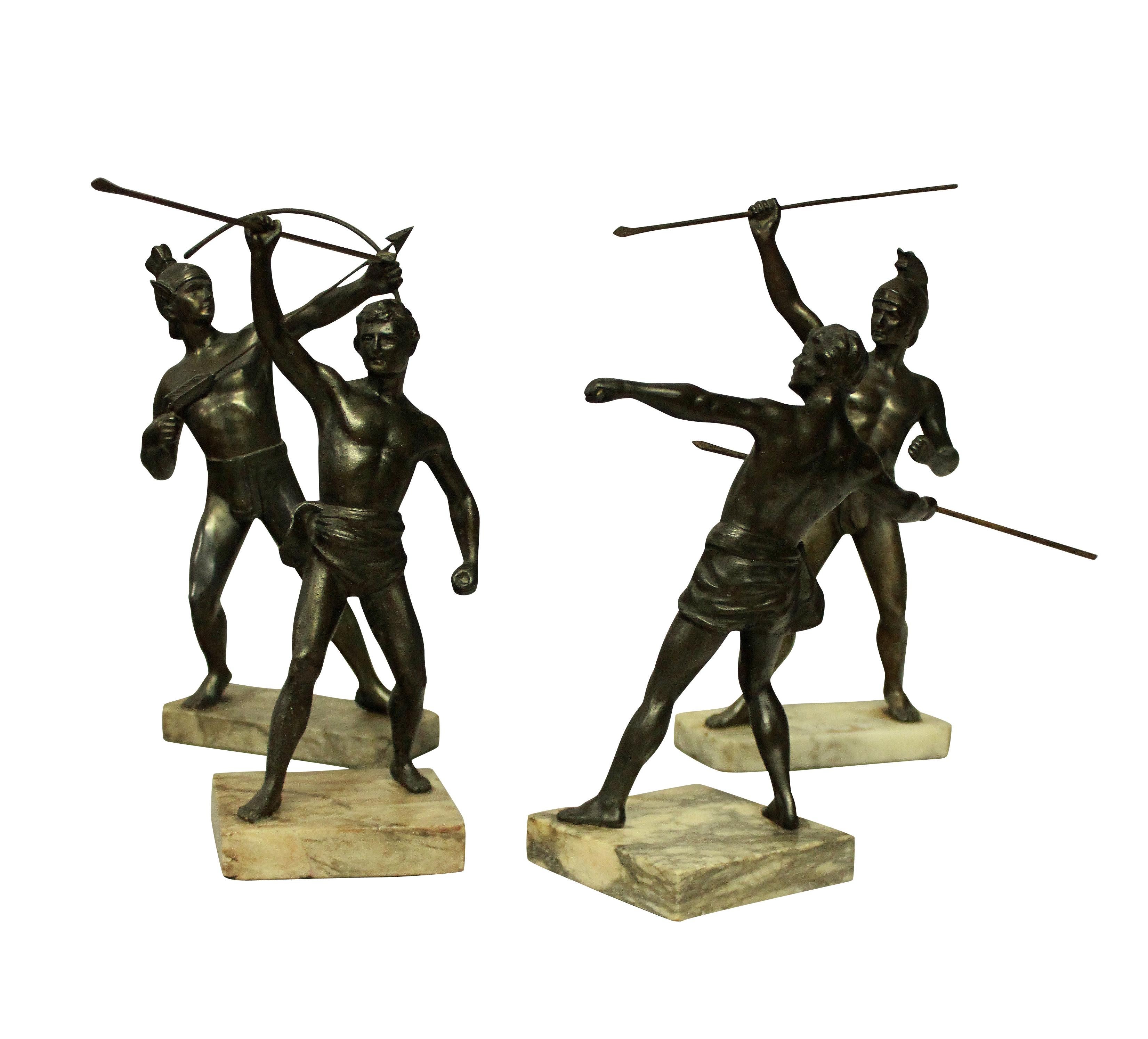 A group of four bronzed spelter Greek & Trojan warrior figures, on marble plinths.