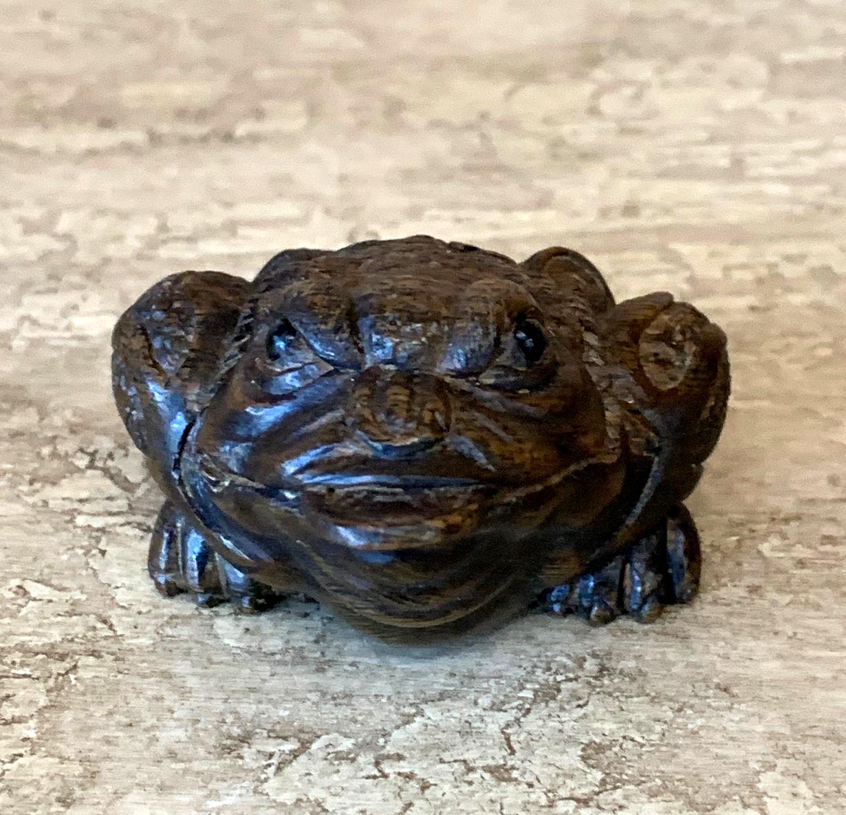 A group of four Japanese Netsukes of various form carved out of the wood and finished in a dark stain, all four appear signed by the same artist Yoshitoshi? (A little hard to decipher the signature for certain); and they are likely dated to early