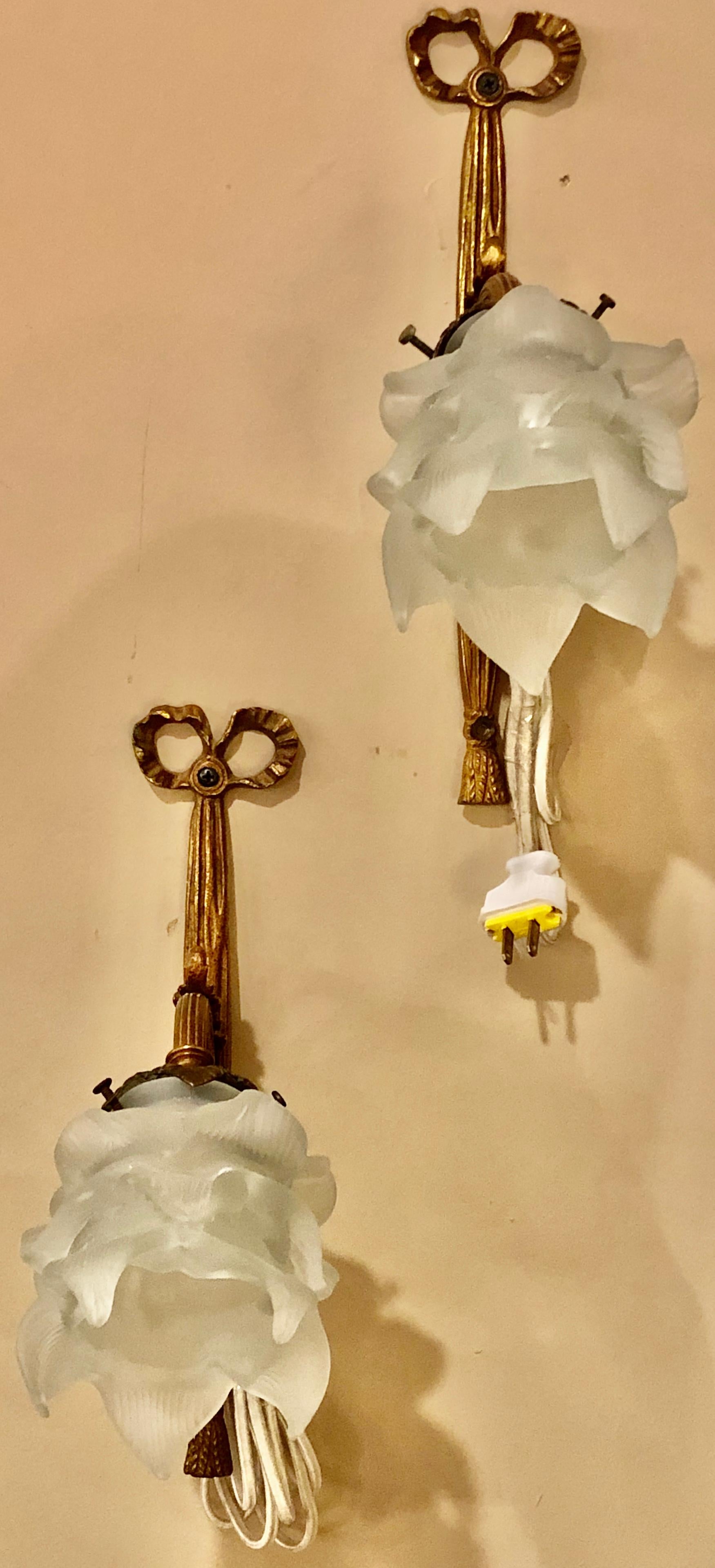 Group of four Louis XVI style bronze sconces with Lalique style shades. Each having a single light covered by a lalique style floral globe. The back of ribbon and bow tassel form from the Louis XVI fashion.