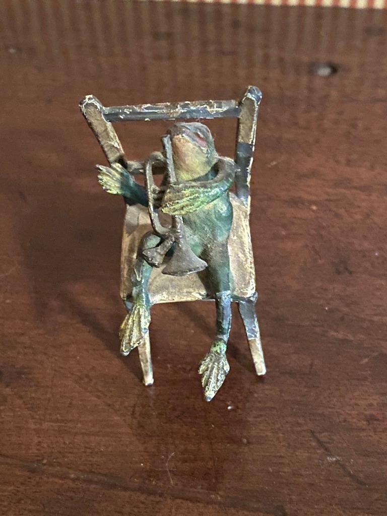 A handcrafted group of Frog Musicians, sitting on a bench and two chairs. There is some
loss to paint. Otherwise they are very well done.