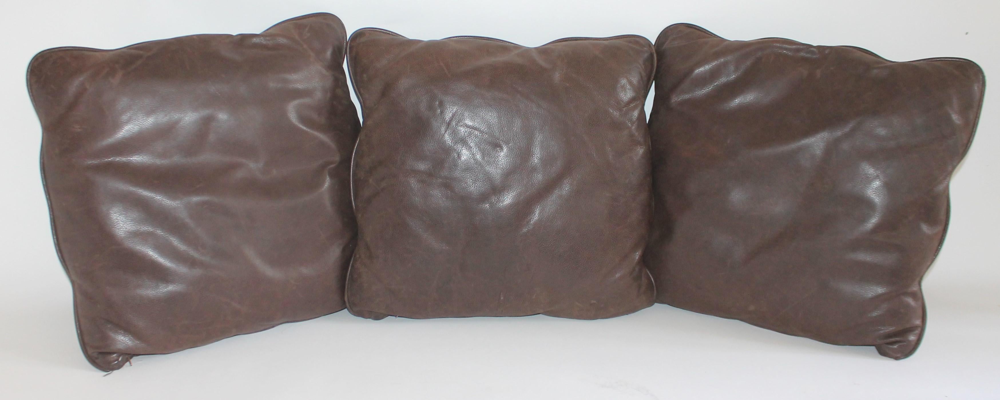These fine distressed Italian kid glove leather pillows are in fine condition with zippers for removing or cleaning. Sold as a group of three.