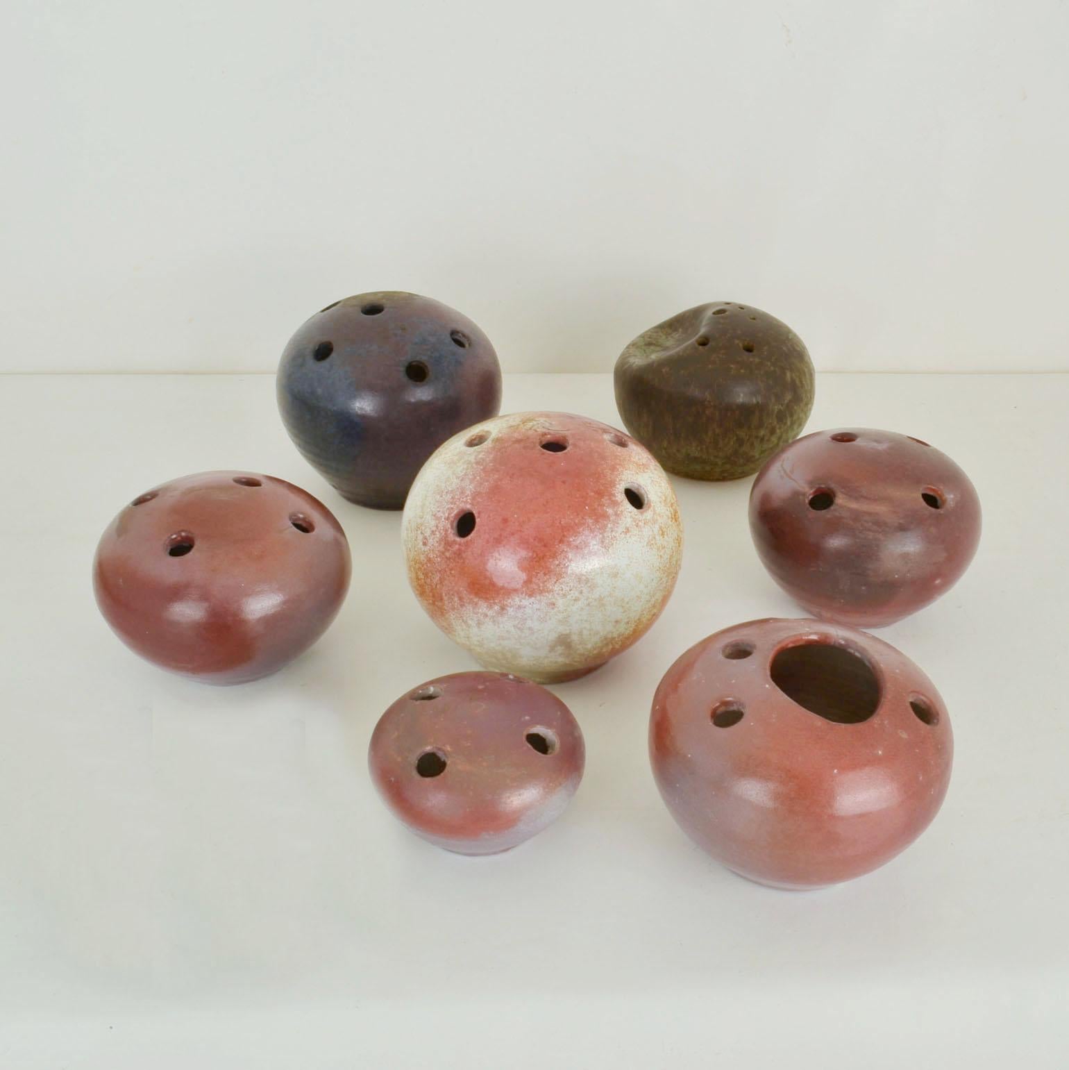 A group of seven organic ball shaped Studio Pottery vases in natural colours, were produced in the 1960s. The individual appearance is unique in their shape, glaze and texture resembling the pebbles we find in nature. This one off collection was