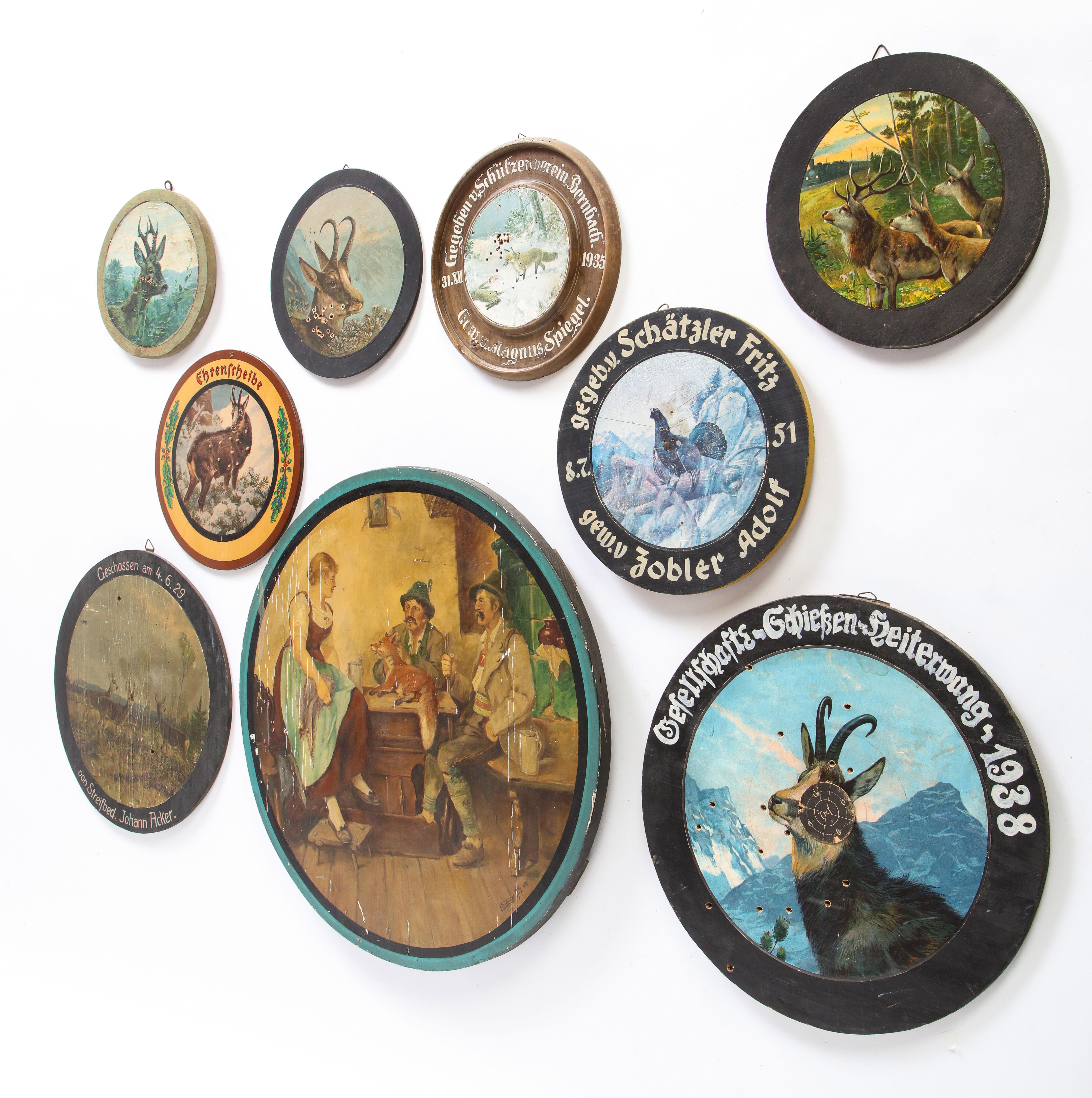 A group of nine trade signs, dart boards, marketing signs and game boards, probably Austrian, from the 20th century. All take circular form, but are of varying sizes. Each is characterized by text, wildlife scenes, and other imagery.

Property from