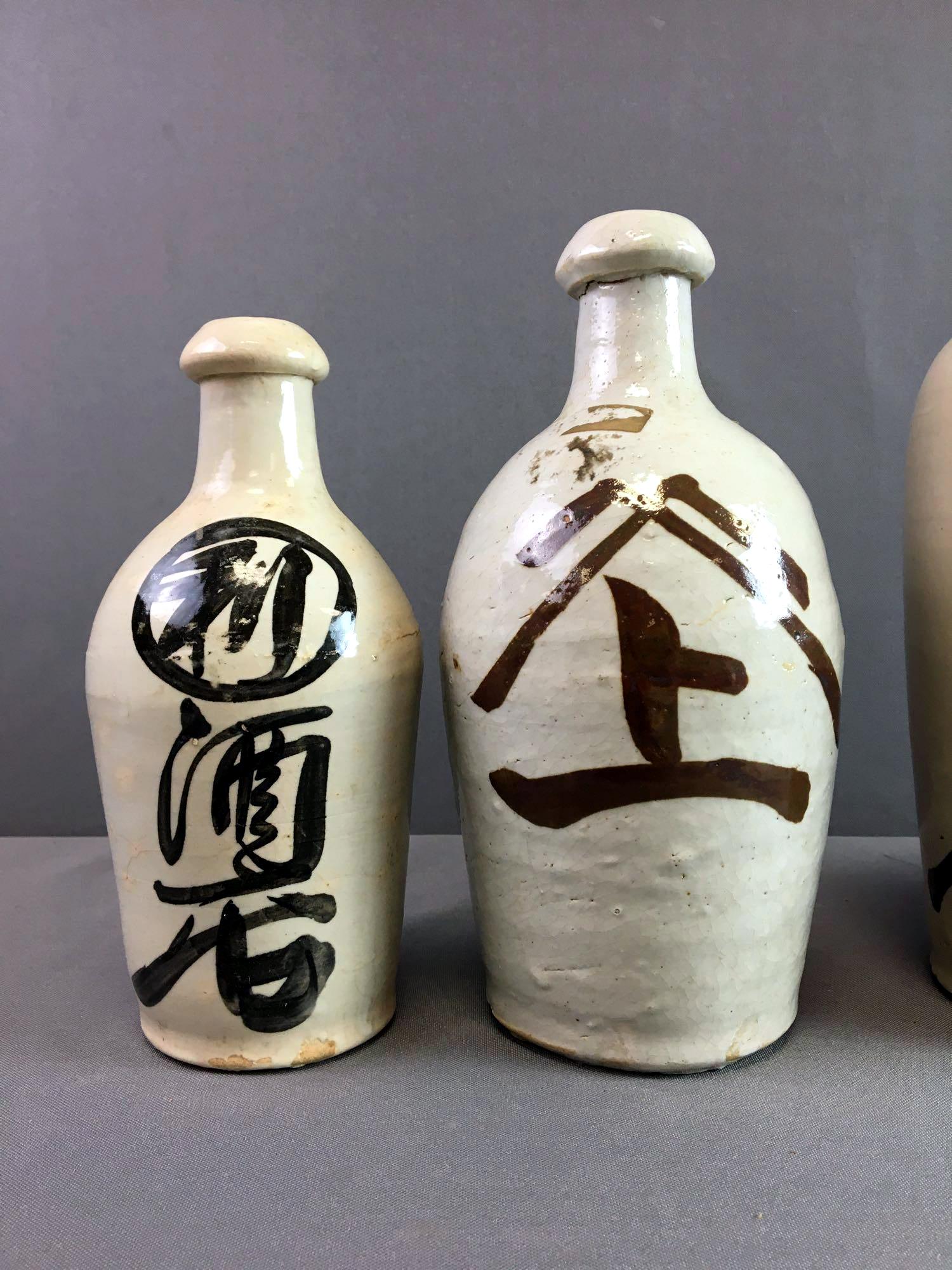Stoneware Group of Nine Vintage Japanese Sake Bottle