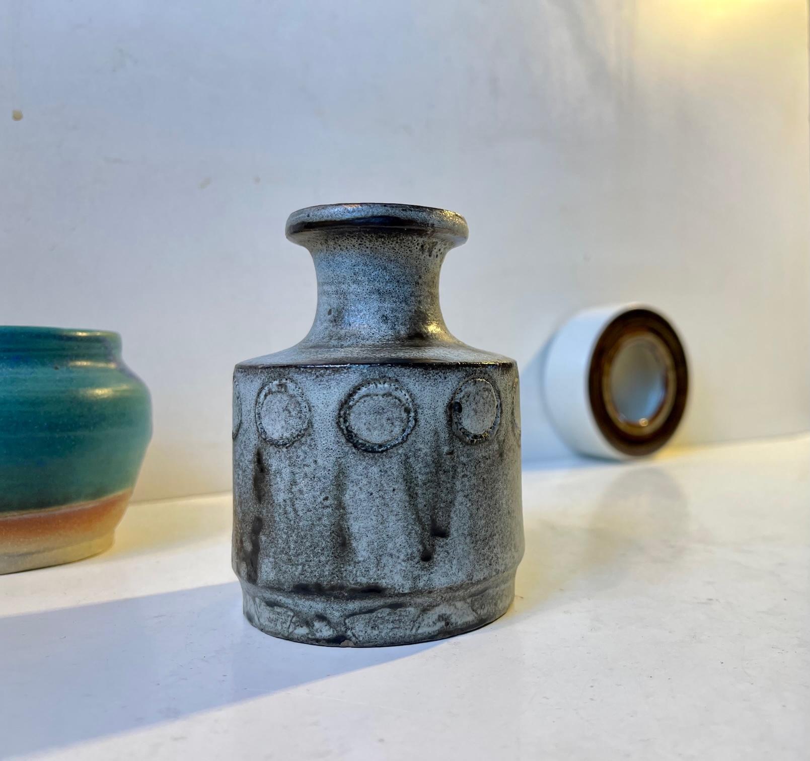 Mixed/curated group of 3 Scandinavian ceramic/stoneware pieces. Number one with a dusty blue/green turquoise glaze, a Hammershoi inspired vase with ash-based glaze and a small cylindrical vessel/dish with earthy striped glazes. All studio made in