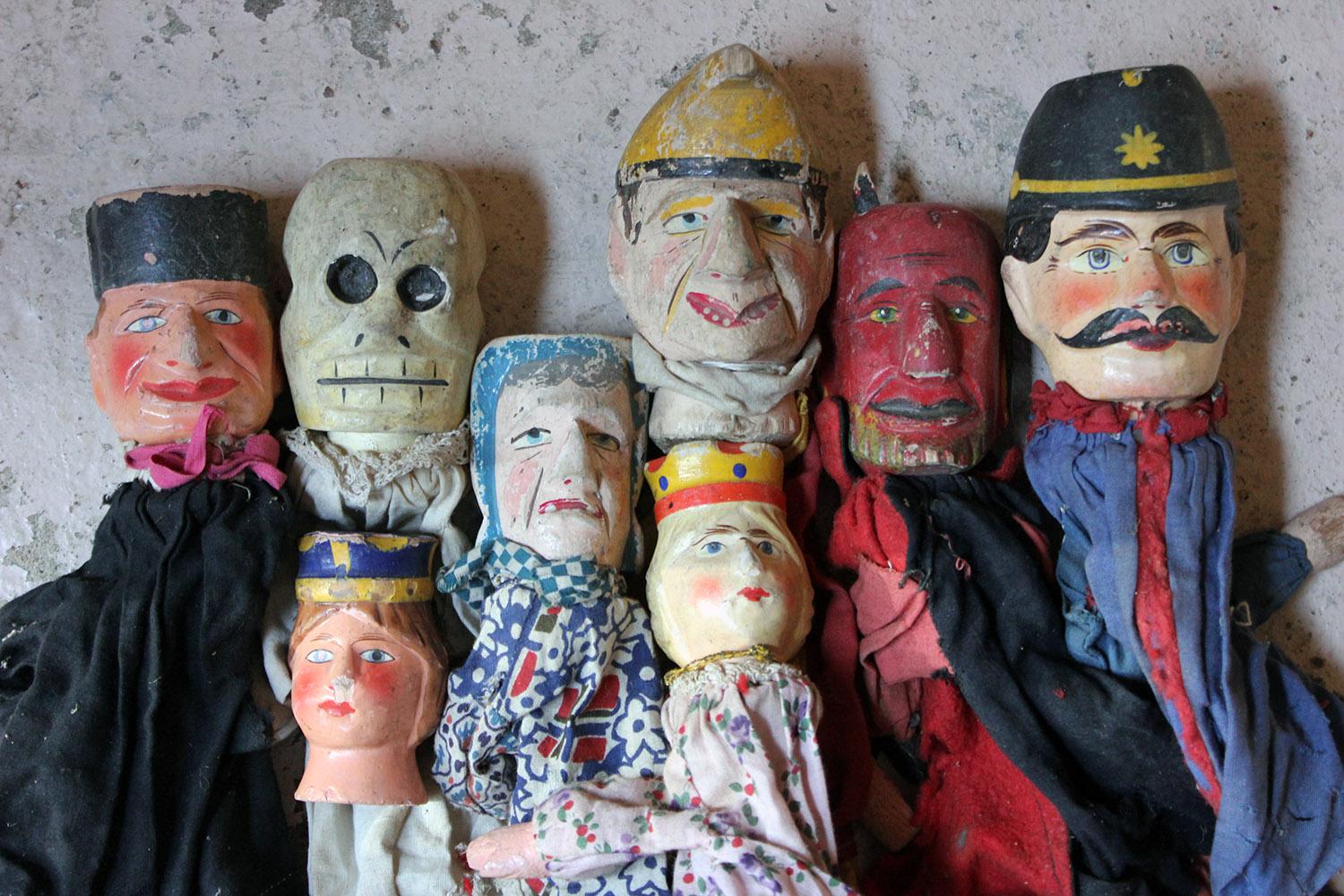 Used by a professional in the zeniths of the 19th century, the charming group of seven finger puppets each with hand carved and painted wooden faces, hands and feet, to tailored cotton clothing, to include Punch and Judy, hangman, constable, devil,