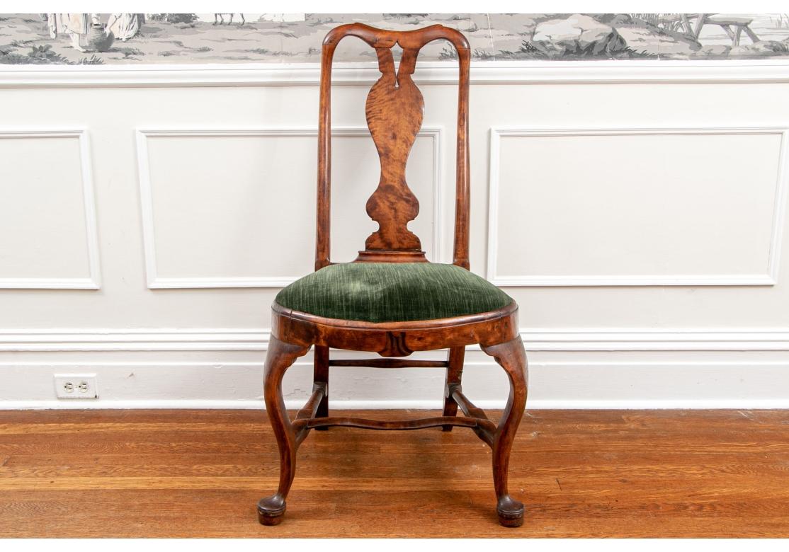 Ca. 18th century. Including two pairs of complementary side chairs, along with two complementary armchairs. All heavy construction in burled wood with classic Queen Anne style shaped splats. The side chairs with plain shaped crest rails and splats