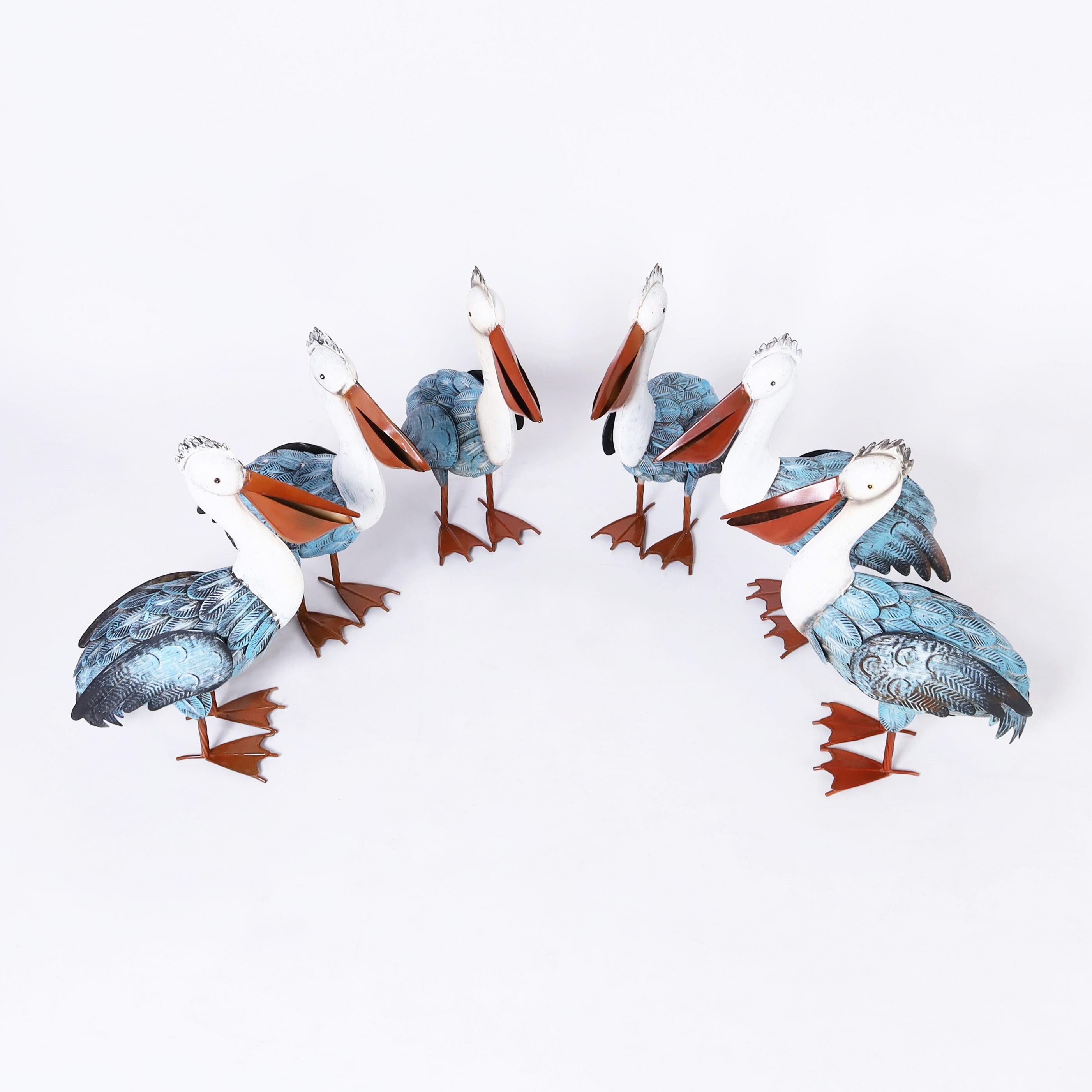 Flock of pelicans hand crafted in metal in a charming stylized form, painted and ready for a new environment. Priced per pair.