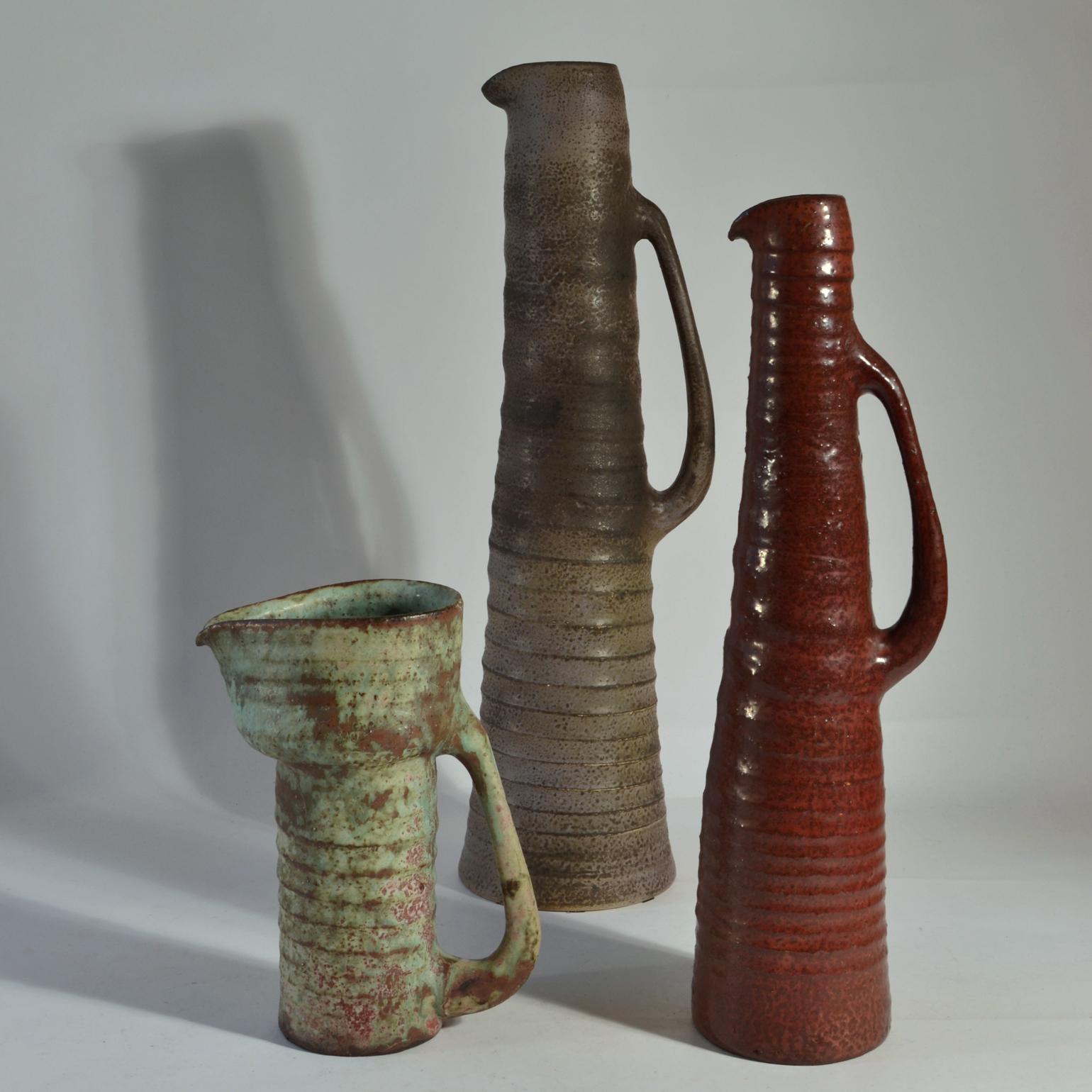 Rare group of six whimsical jugs / vases with long downward ears in various heights with earth tone glazes in muted colours. They are like sculptures with almost human character created on the turning wheel by highly technical skilled Dutch Mobach
