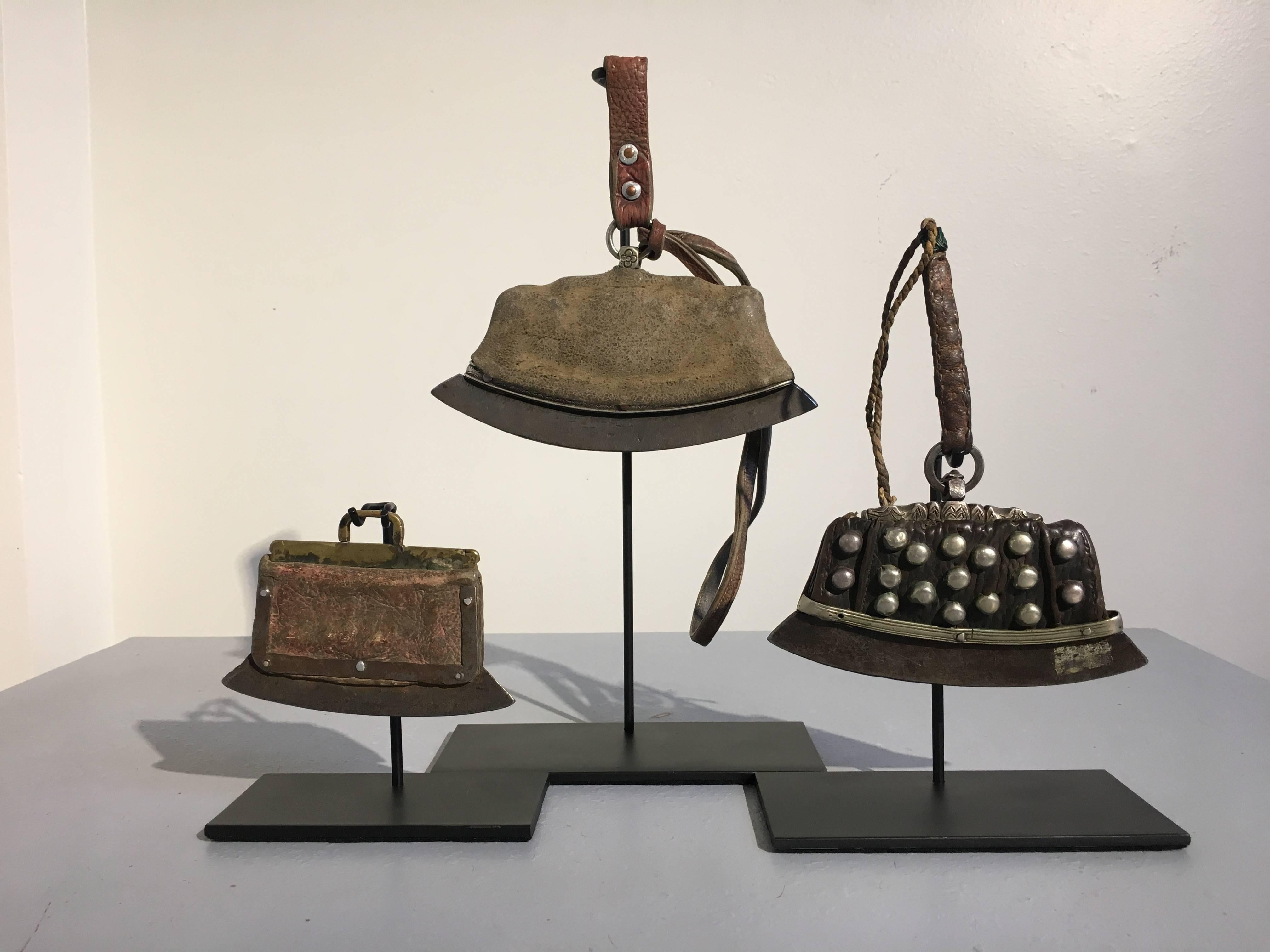 A very nice group of mounted early 19th century Tibetan leather and silver purses. The purses originally used to carry tinder and flint, with the two larger purses still containing fire starting materials. The pouches are made from leather with a