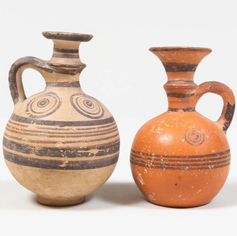 Group of three ancient Cypriot/Greek iron age geometric period pottery vessels - one larger amphora & two oinochoe (or wine jug), dating to circa 750-500 BC. 

Measurements: 
Largest Pot with Stand: 5.5
