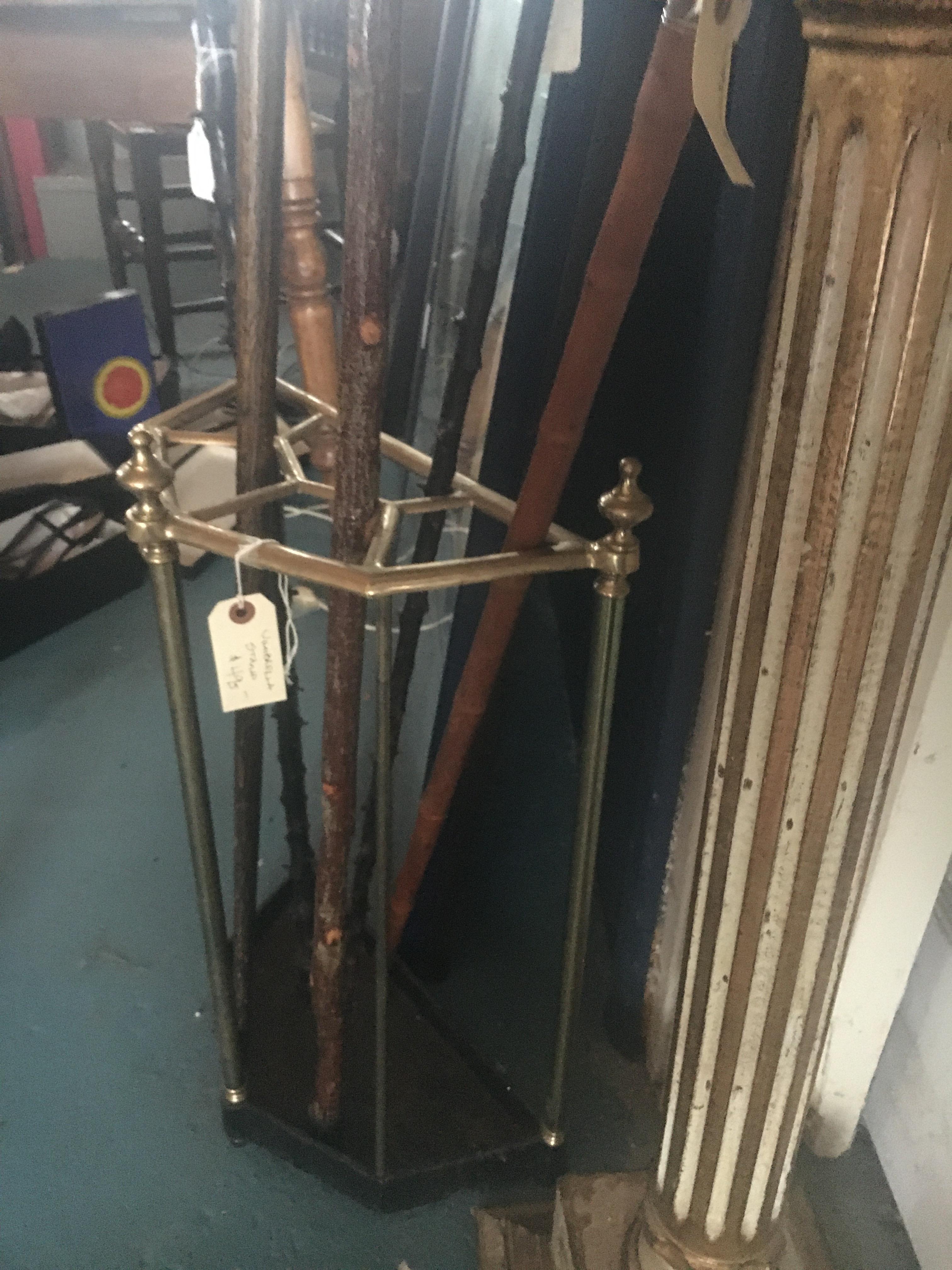 An English brass and iron umbrella stand.  Nice old mellow patina.  Great display for a collection of canes. We also have other umbrella stands.  Feel free to call with further questions.