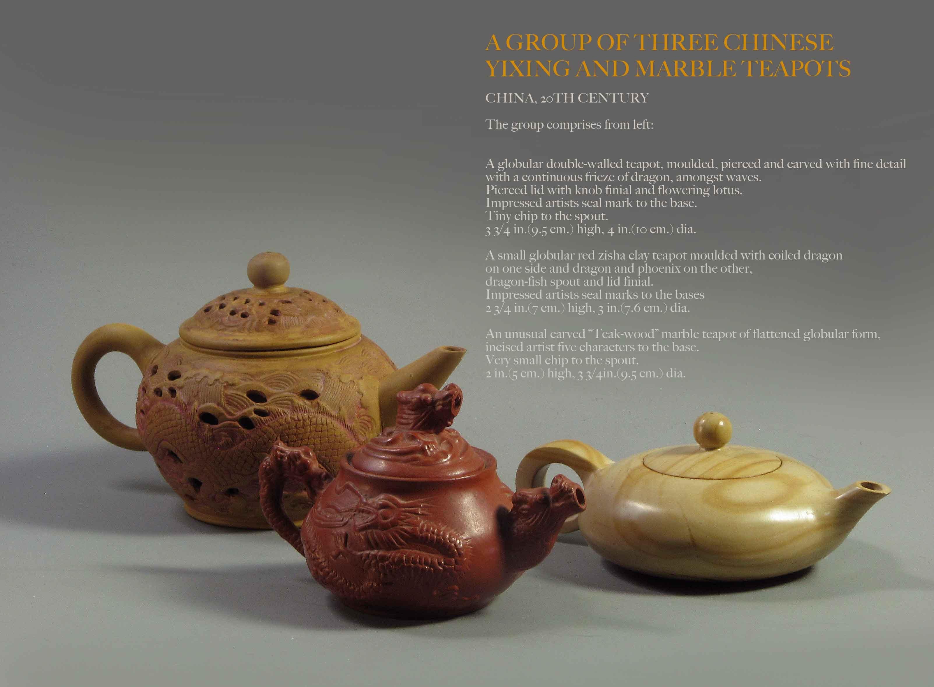 A group of three Chinese
Yixing and marble teapots
China, 20th century
The group comprises from left:

A globular double-walled teapot, moulded, pierced and carved with fine detail
with a continuous frieze of dragon, amongst waves. 
Pierced