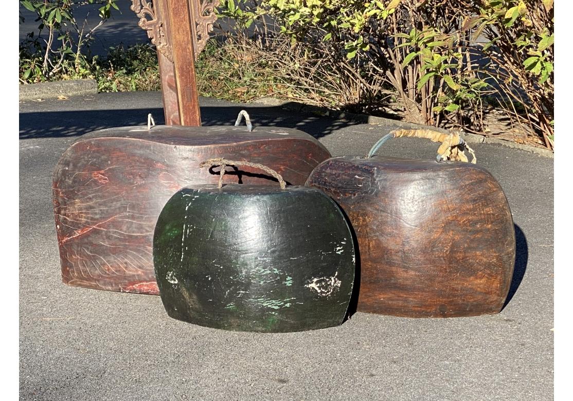 A very decorative and sculptural group of three carved wood Bells In Elliptical form likely Japanese or Indonesian. Reminiscent of the sculpture of Constantin Brancusi, the elemental forms project  both power and serenity. Hand-carved teak wood with