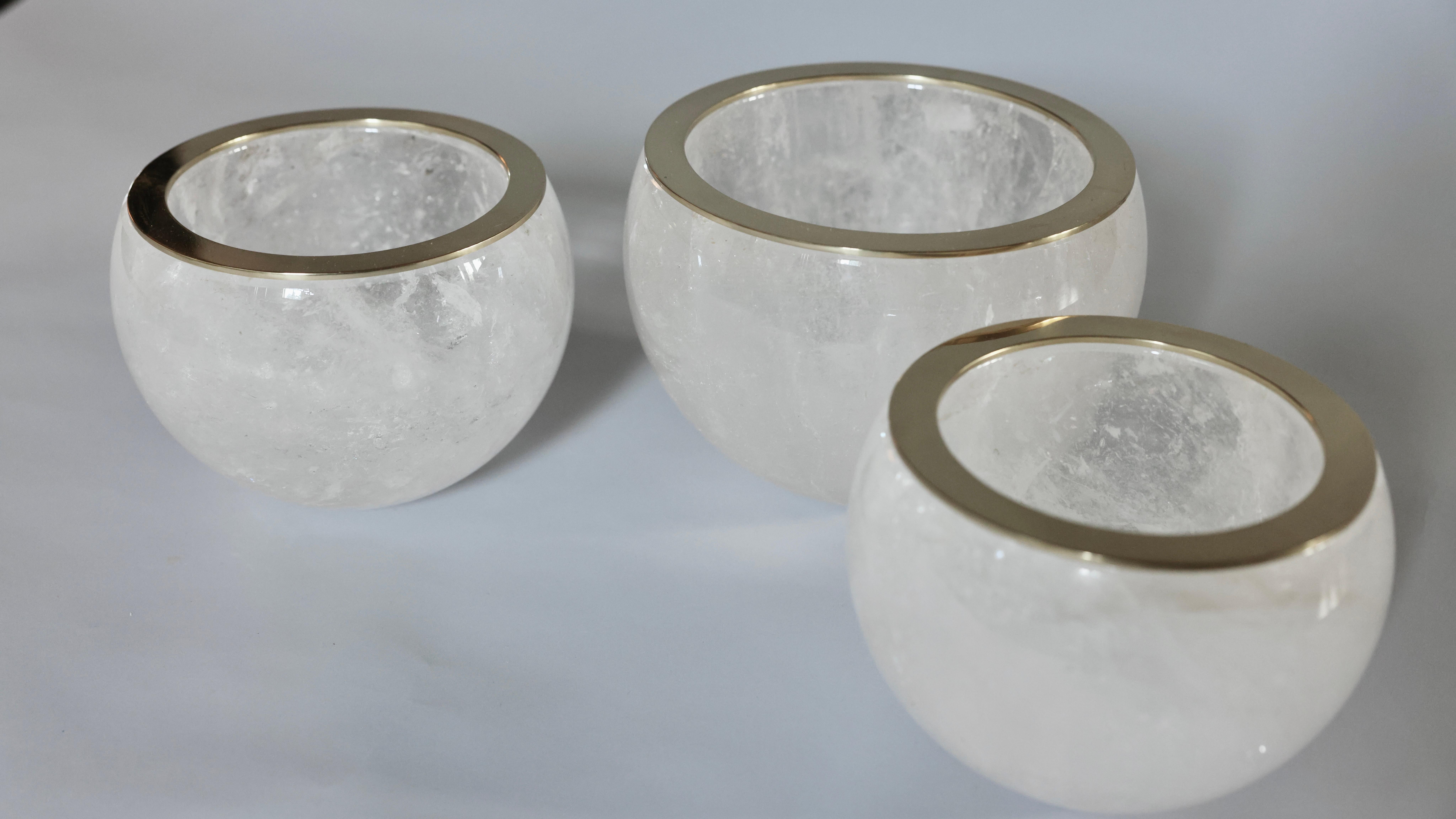 Group of three rock crystal bowls with polish brass rim.created by Phoenix.