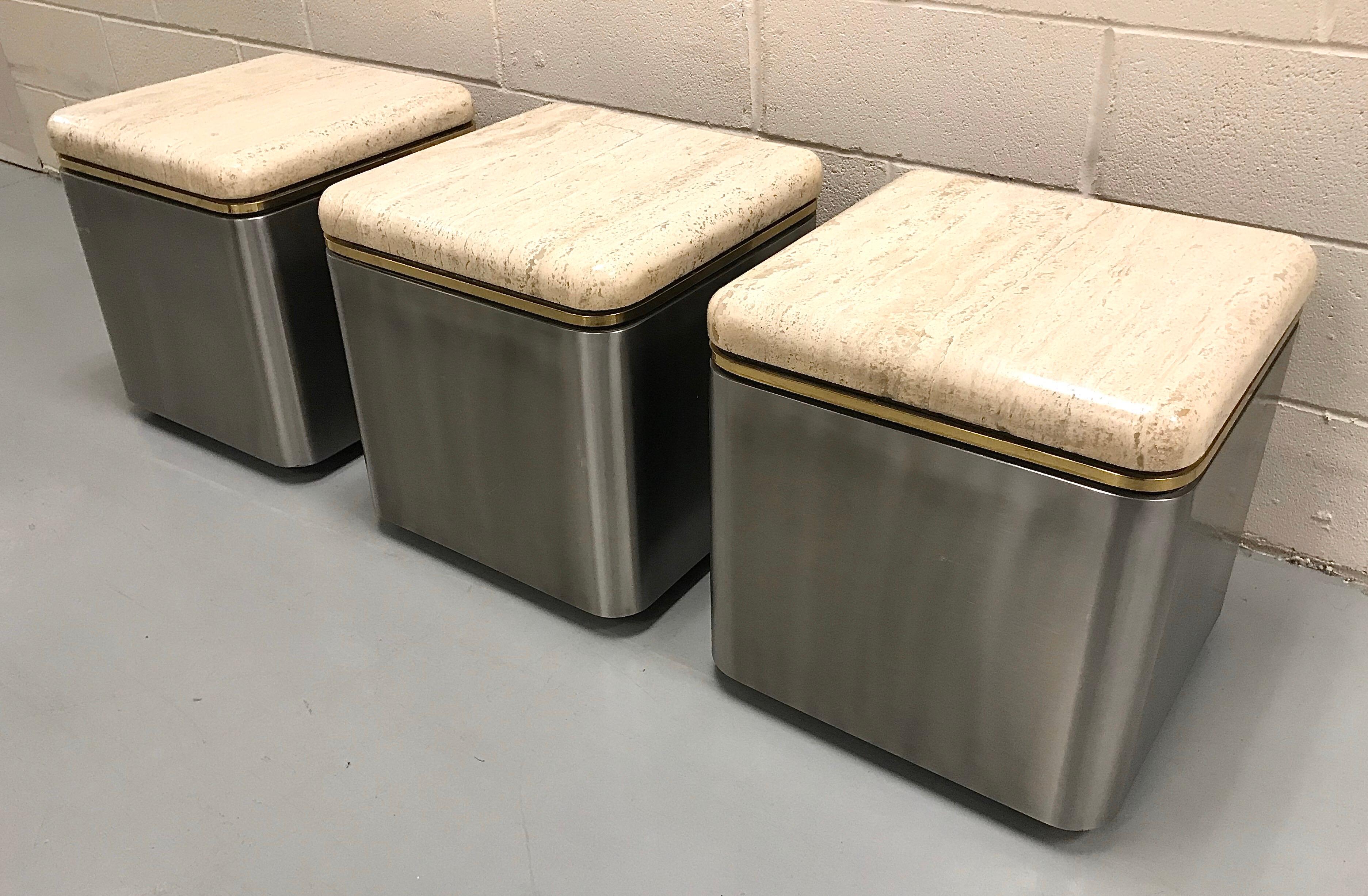 Very well built group of three stainless steel, brass and travertine tables on casters, USA, 1980s.