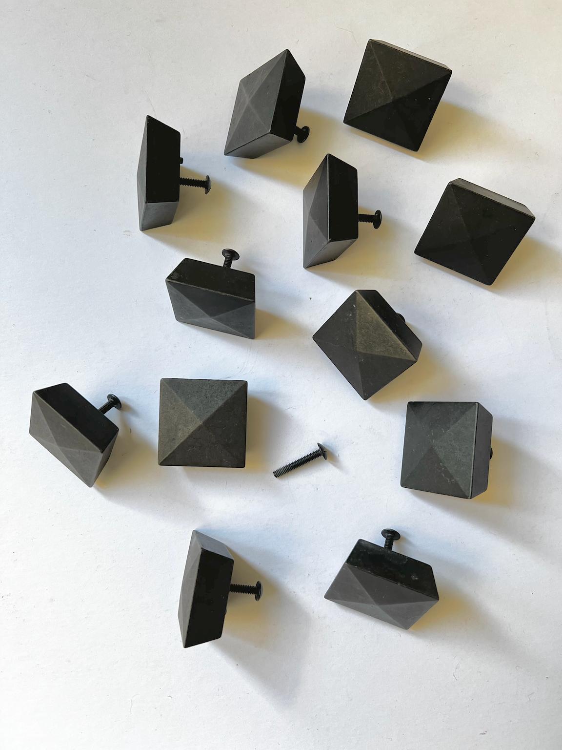 A group of 12 vintage square furniture handles or knobs, with bolts, nicely shaped with a pyramid face and sloping sides. Second half twentieth century, found in England.

The handles look to be cast and patinated bronze - almost black - with an