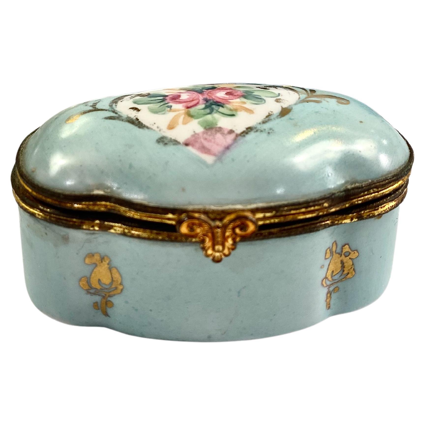 This is a charming grouping of three early 20th century dressing table boxes or table decorations. Two of the boxes are hand painted, French bronze mounted. The third box is Wedwood in the deep Portland Blue. All three boxes are in overall good