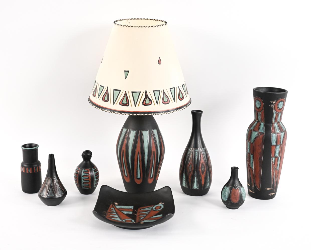 A fabulous collection of eight pieces of Danish mid-century pottery, designed by Marianne Starck for Michael Andersen & Son. This grouping includes six vases, a dish, and a lamp with a hand-painted shade, all from the same collection in matching