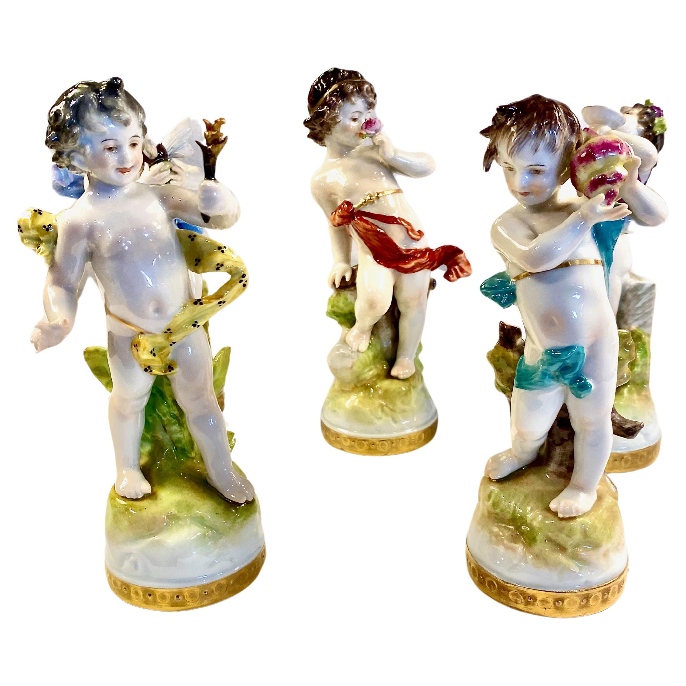 This is a set of 5 Rudolstadt Volkstedt Figurines representing various putti or cupids. The figurines are beautifully detailed with hand painting, scrolling drapery and holding flowers, a shell and even a bee. All five pieces are in very good