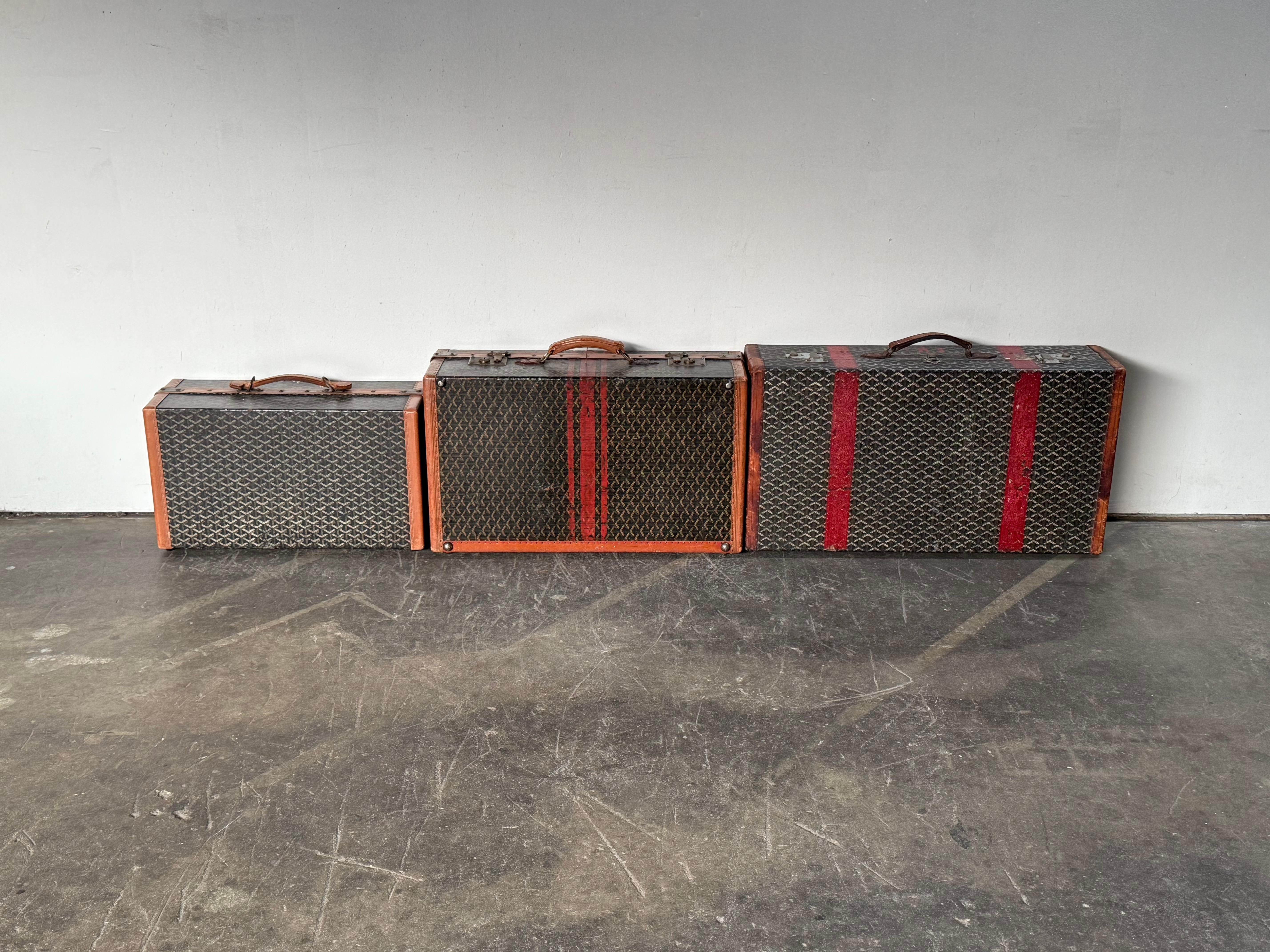 Grouping of three original Goyard suitcases/wardrobe trunks. All signed and guaranteed authentic. In original unrestored as-acquired condition. Bright and clear signature Goyard prints, each piece depicting its own nuance and patina. Leather handles