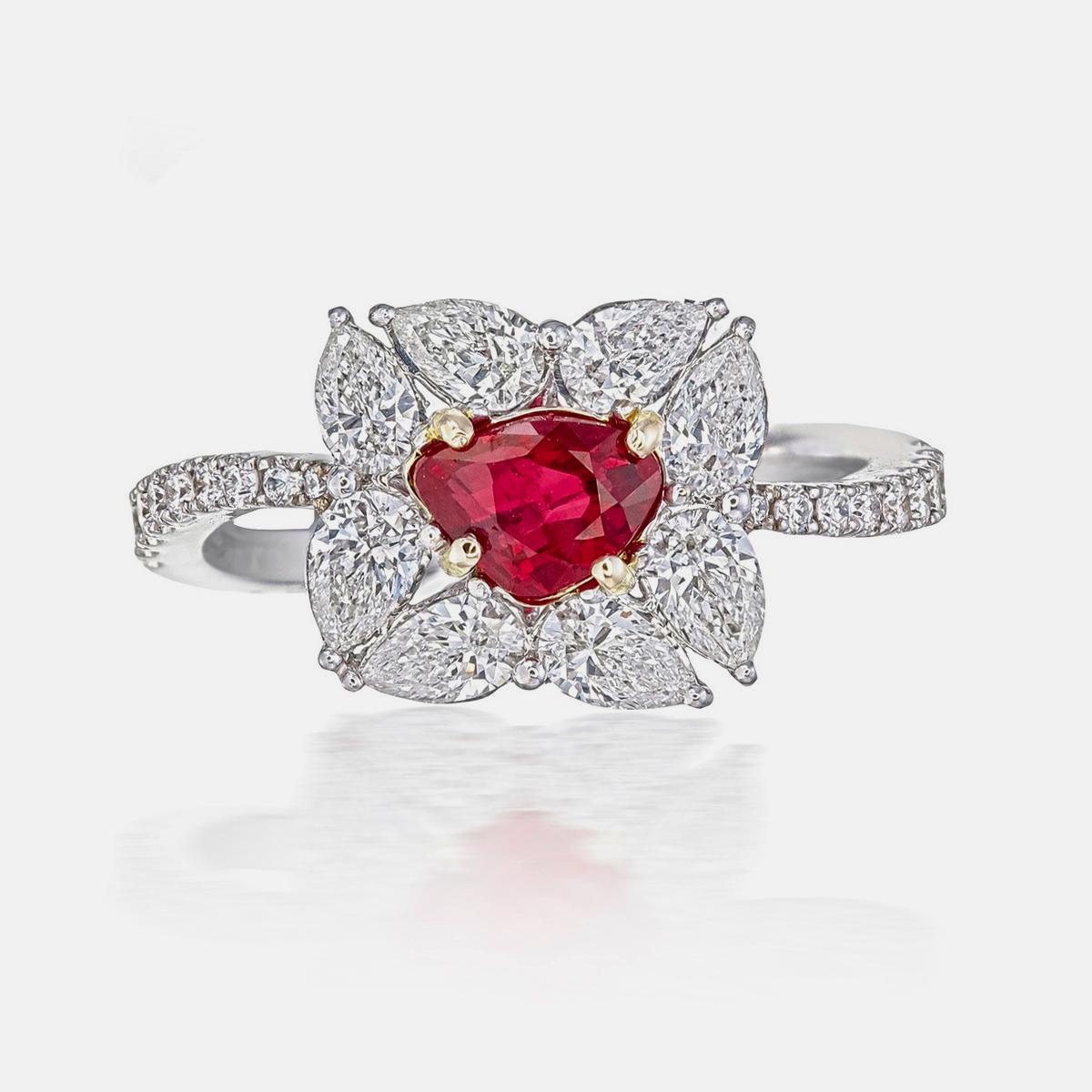A ‘Pigeon Blood’ red hue ruby and diamond solitaire ring made in 18 Karat gold. A classic design with a unique triangle shaped ruby. This ring is a good fit for everyday use and for special occasions.  

    The center stone is a cushion shaped 1.00
