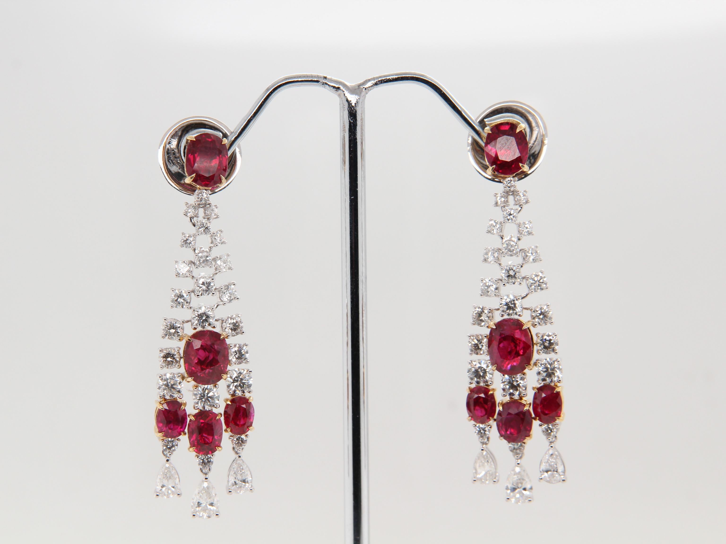 An elegant pair of vivid and lustrous pigeon blood Burmese ruby and diamond chandelier earrings. The ruby's shining luster is complimented by the sparkling diamonds, this helps to exude elegance. The ruby weighs 5.18 carat and is certified by Gem
