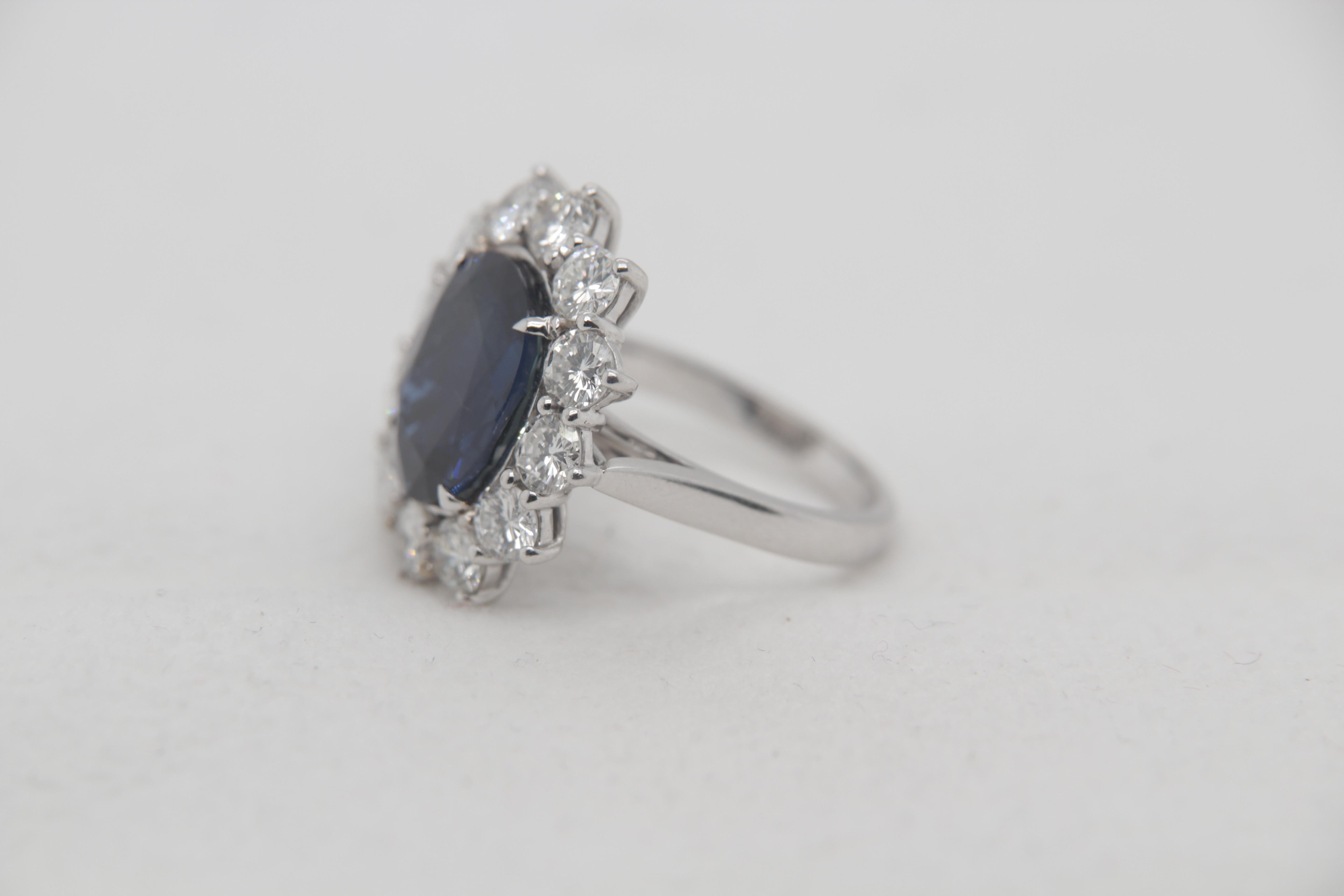 A brand new 7.42 carat Blue sapphire ring mounted with diamonds in 18 Karat gold. The blue sapphire weighs 7.42 carat and is certified by Gem Research Swisslab (GRS) as natural, no heat, and Blue. The total diamond weight is 2.88 carat and the total