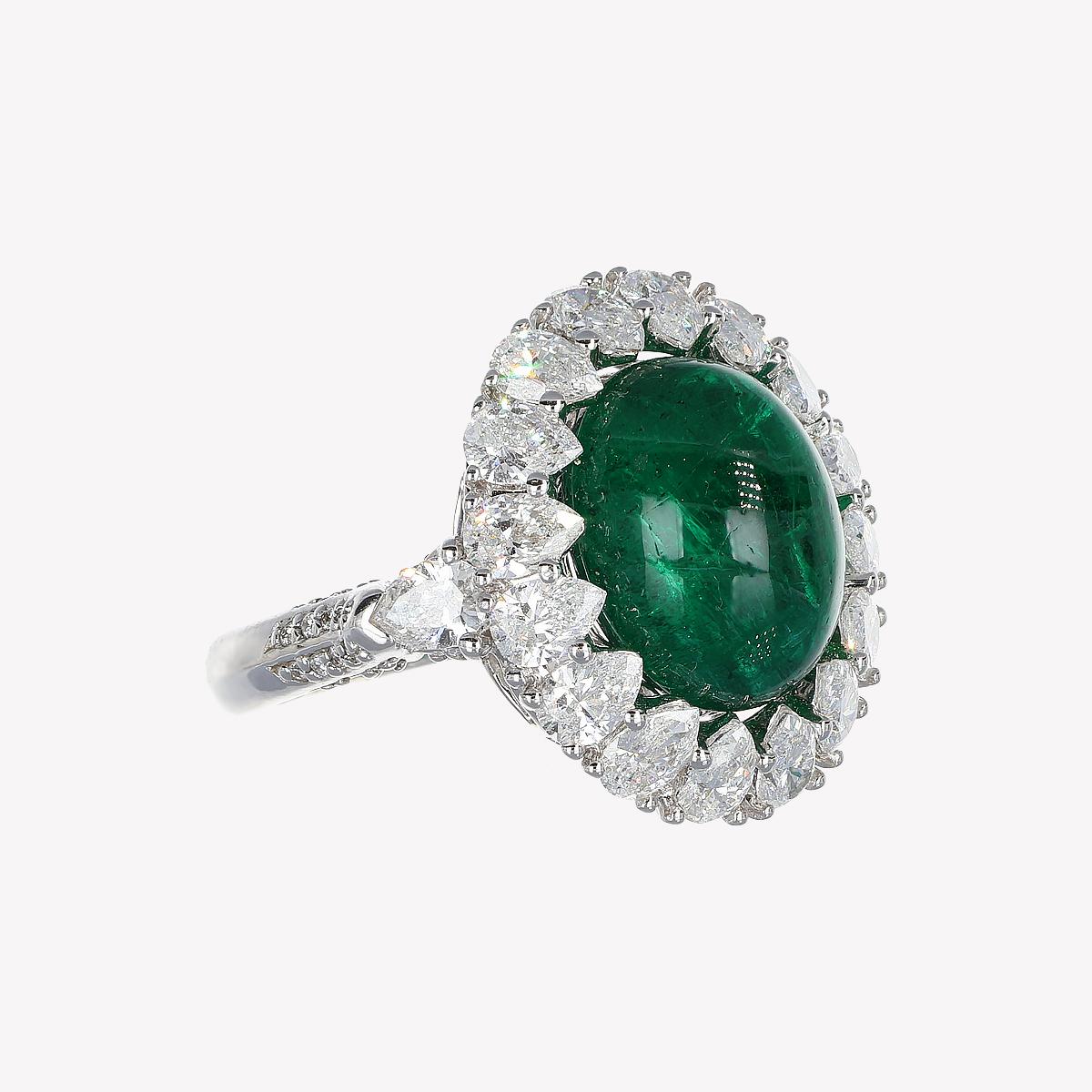 This ring is a hymn to nature and its pristine beauty, a jewel capturing the vibrant essence of life. The deep green of the cabochon emerald, hailing from the fertile lands of Zambia, shines like the heart of an ancient forest, promising prosperity