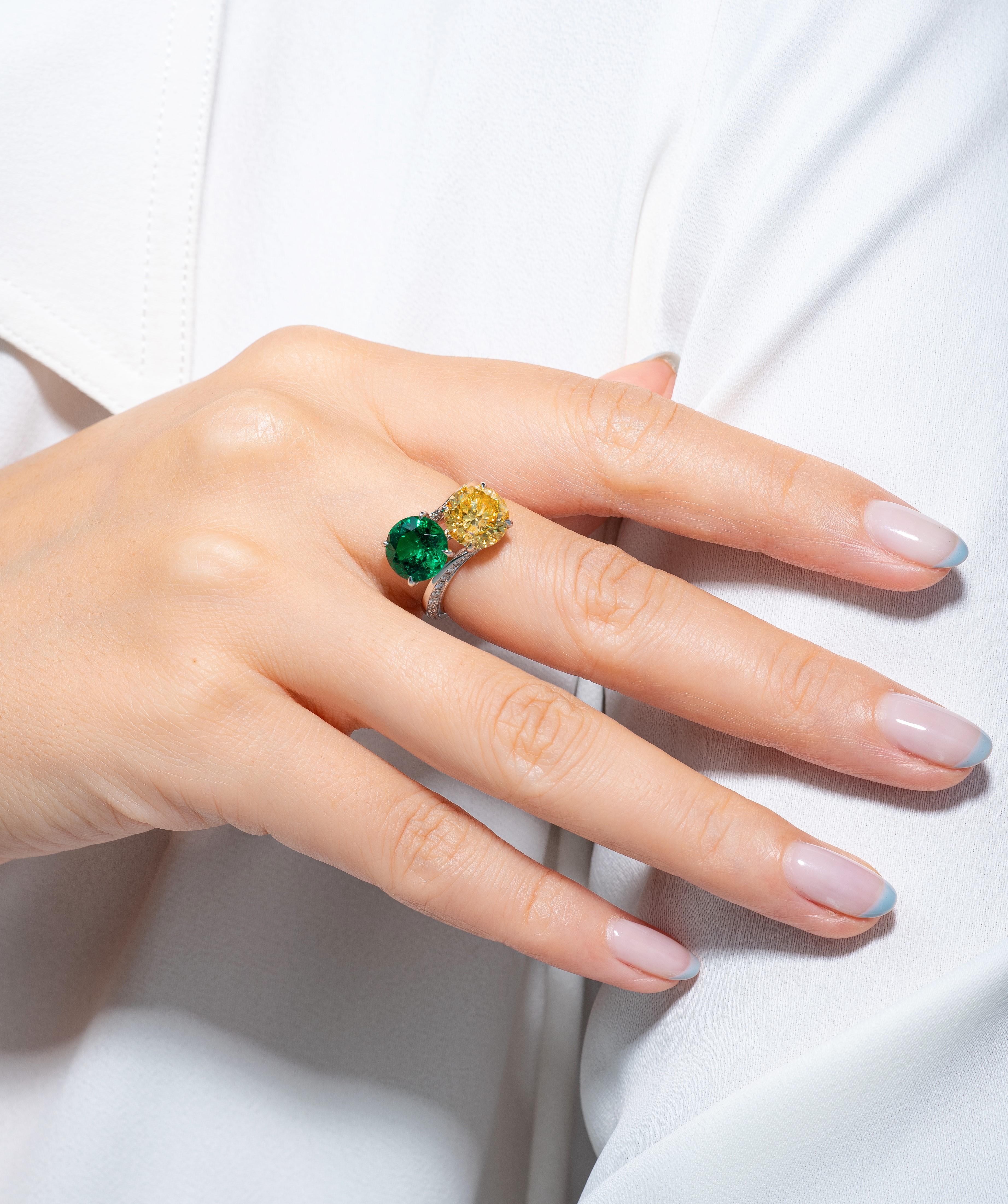This toi et moi ring is a contemporary reinvention on the classic interpretation. Featuring two colored stones, this would make the perfect gift for a woman with a love for fashion and style. The 2.18 carat Colombian Muzo Green round Emerald, which