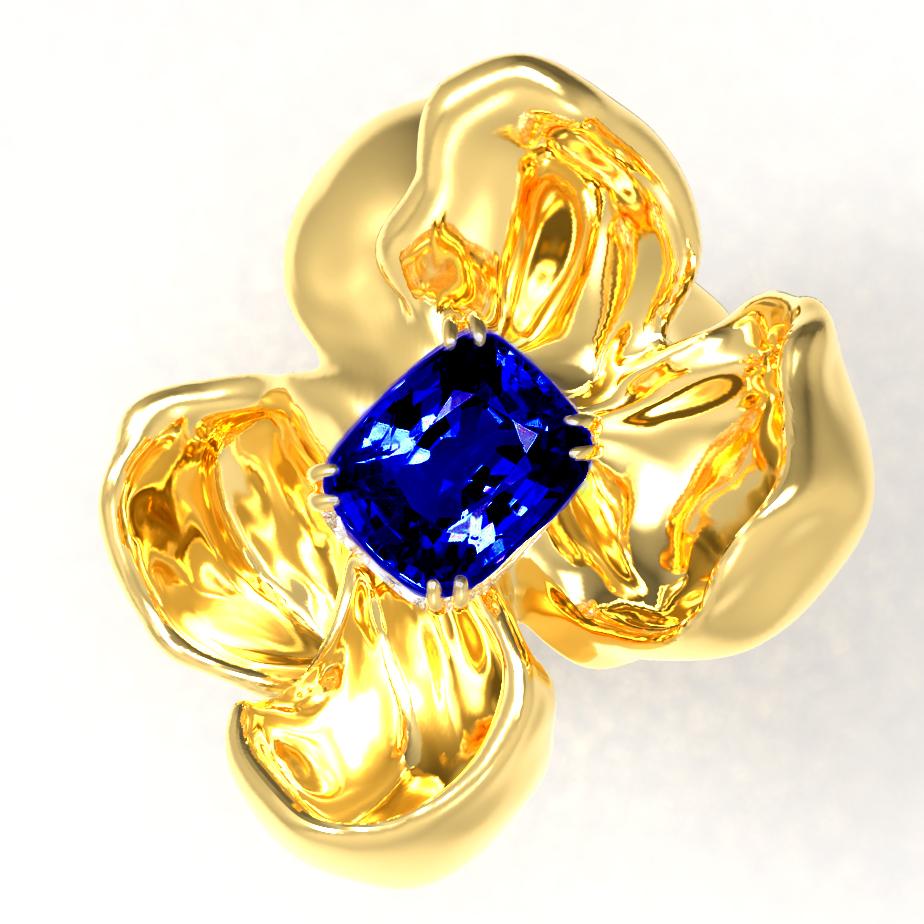 The Magnolia Flower contemporary pendant necklace is crafted from 18 karat yellow gold and features a GRS certified no-heat vivid blue sapphire cushion weighing 1.09 carats. The ring's golden petals reflect light, framing the vivid blue sapphire