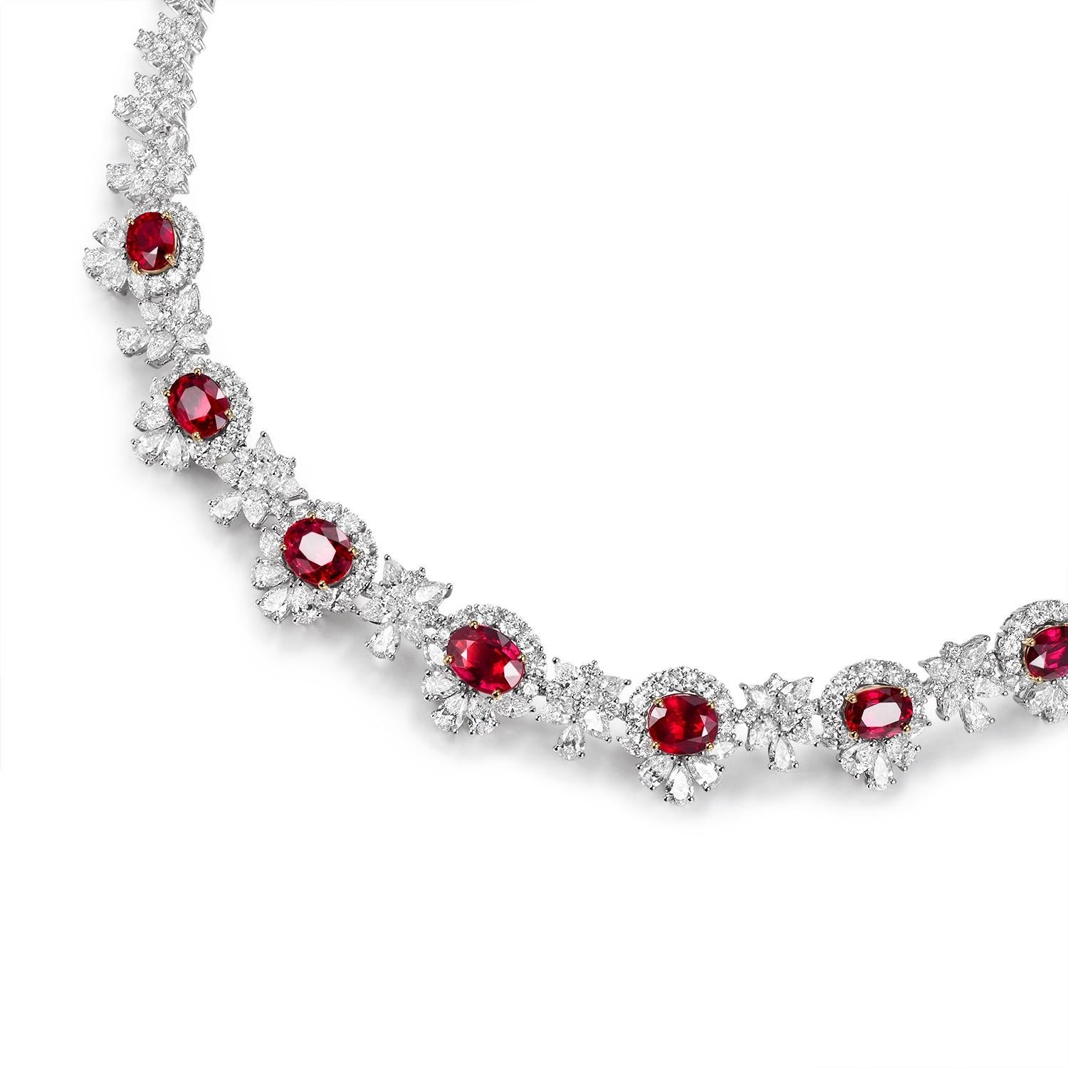This exquisite necklace is a statement piece that exudes luxury and sophistication. Crafted in lustrous 18K white gold, it features a symphony of seven meticulously selected Mozambique rubies, weighing a total of 12.03 carats. These rubies, known
