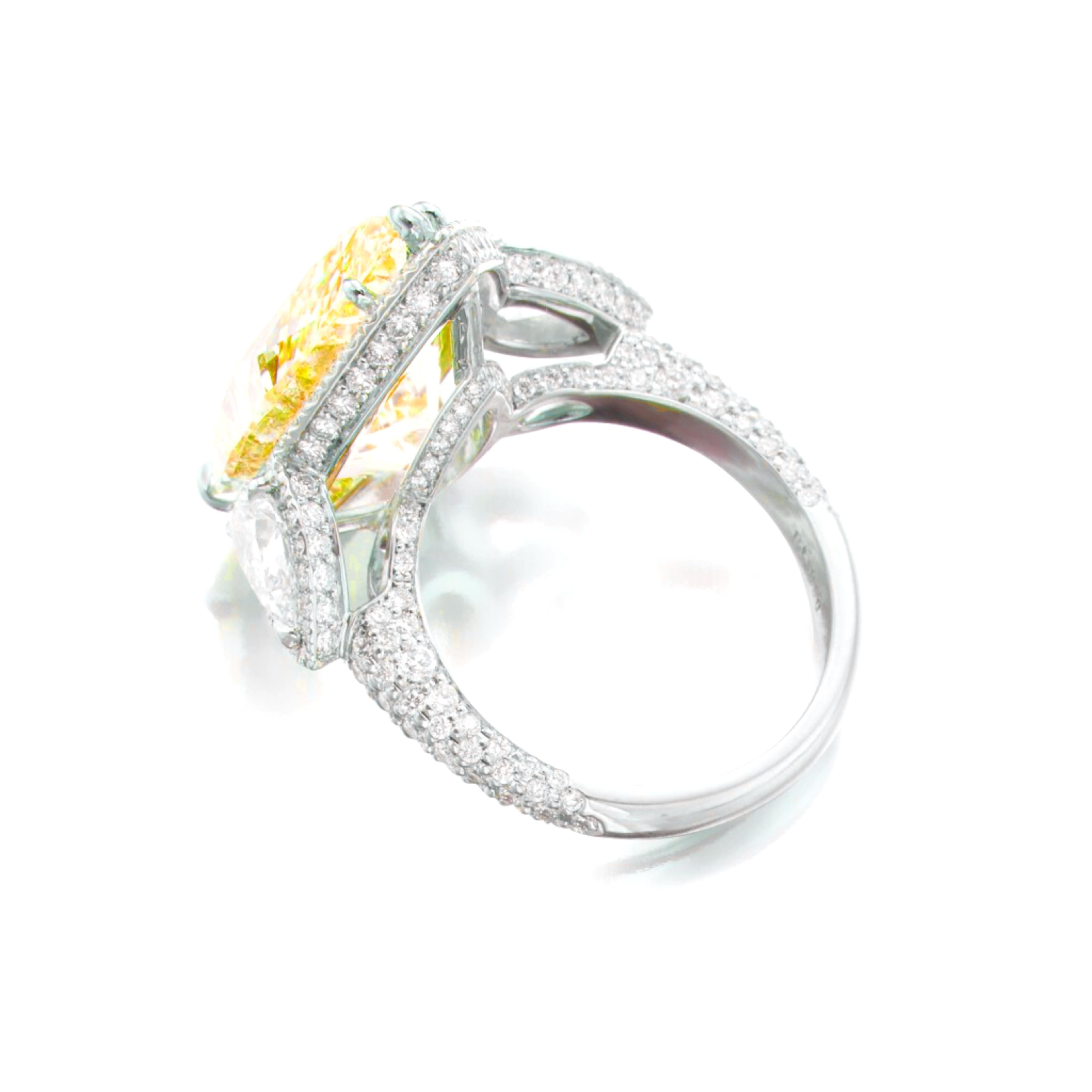 A timeless creation by Cecile Blake, this exquisite ring showcases a vibrant 10-carat fancy yellow, certified by GIA for its fancy yellow  hue and untreated status. 

The pear cur fancy yellow is elegantly surrounded by a halo of brilliant round