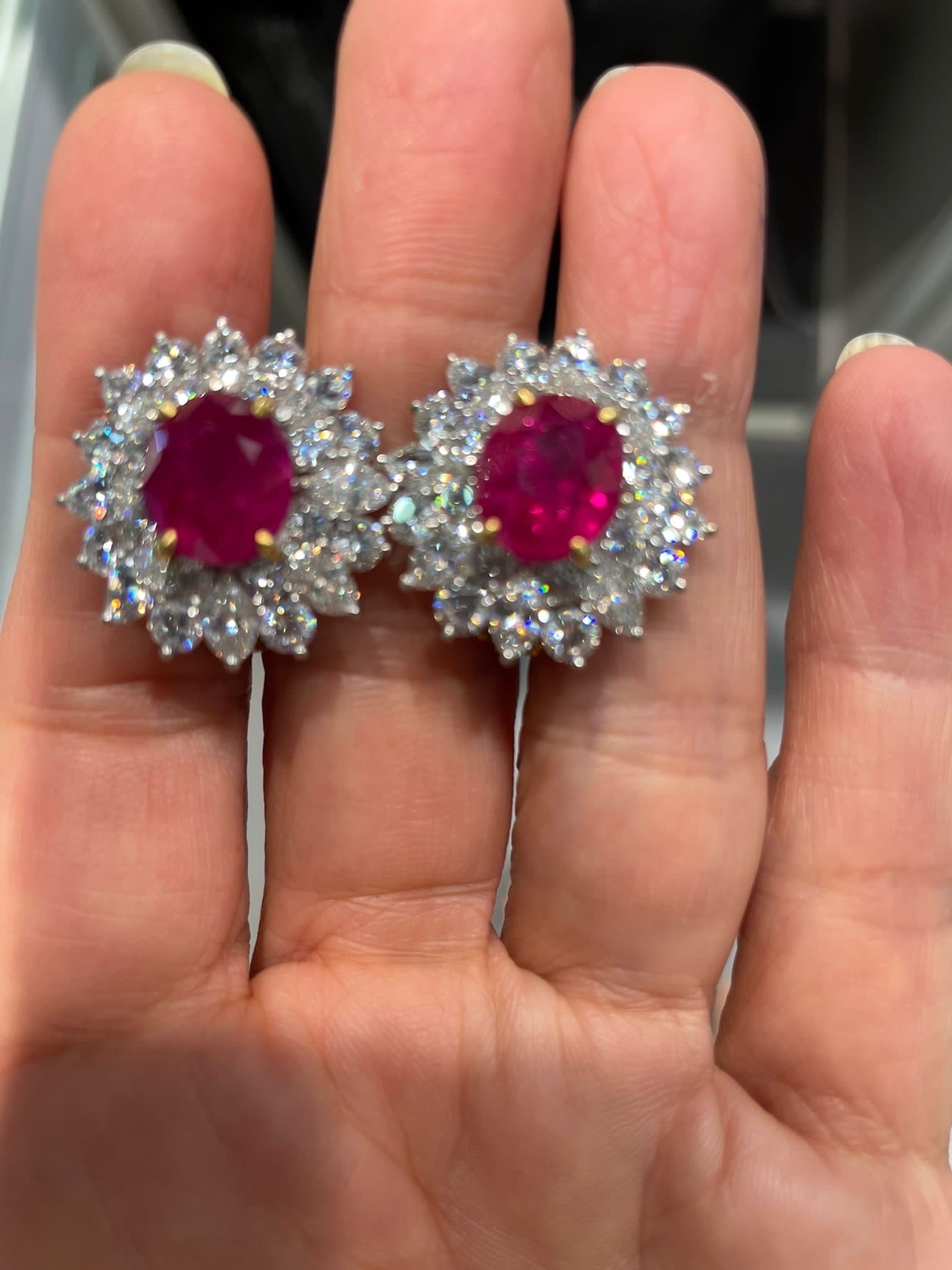 A beautiful pair of total 10.05 carat Burmese Ruby earrings, surrounded with 5.60 carat VS quality F/G color Diamonds set in solid 18K White Gold. 